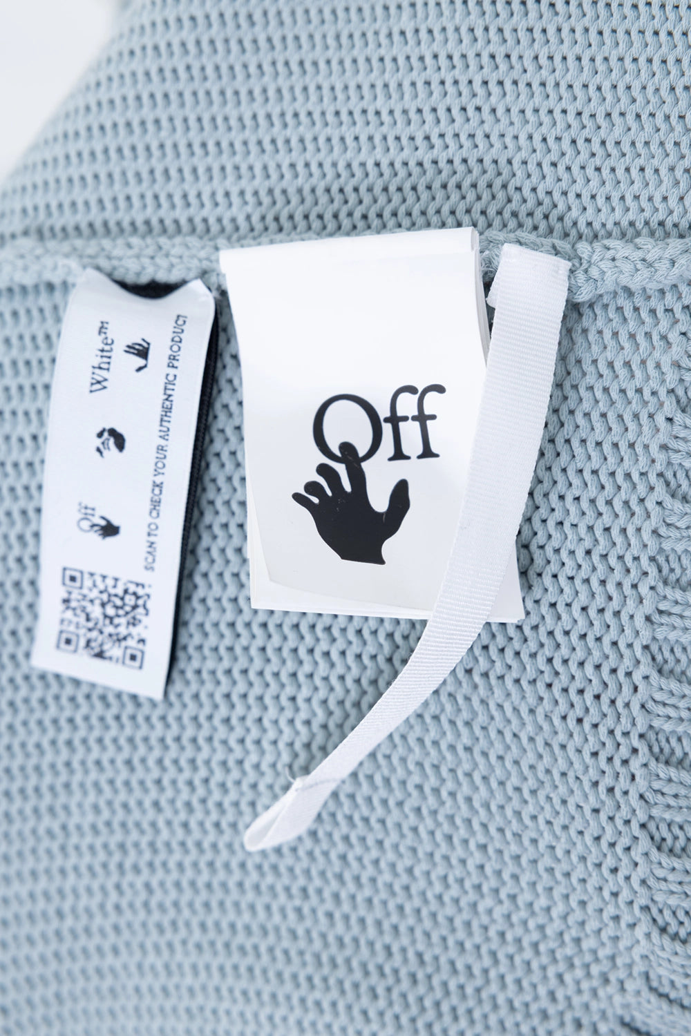 Pre-owned Off-White knit sweater in ice blue, hangtag close-up, Off logo tag with QR label