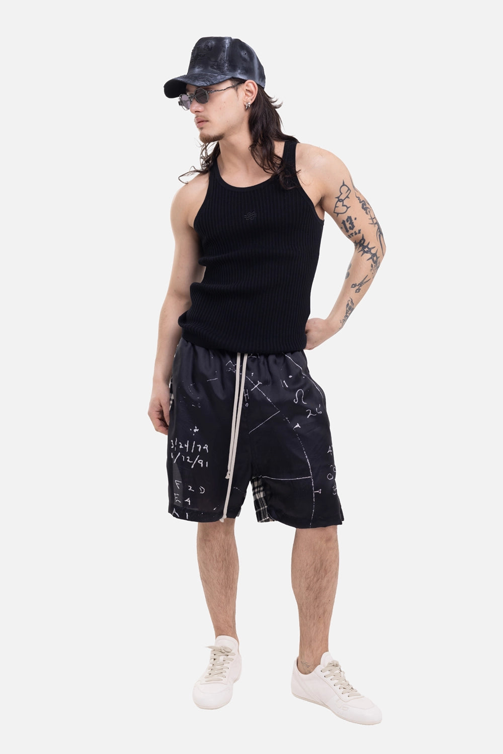 Filling Pieces unisex tank top in black, on-model full-length view with scoop armholes and small chest logo