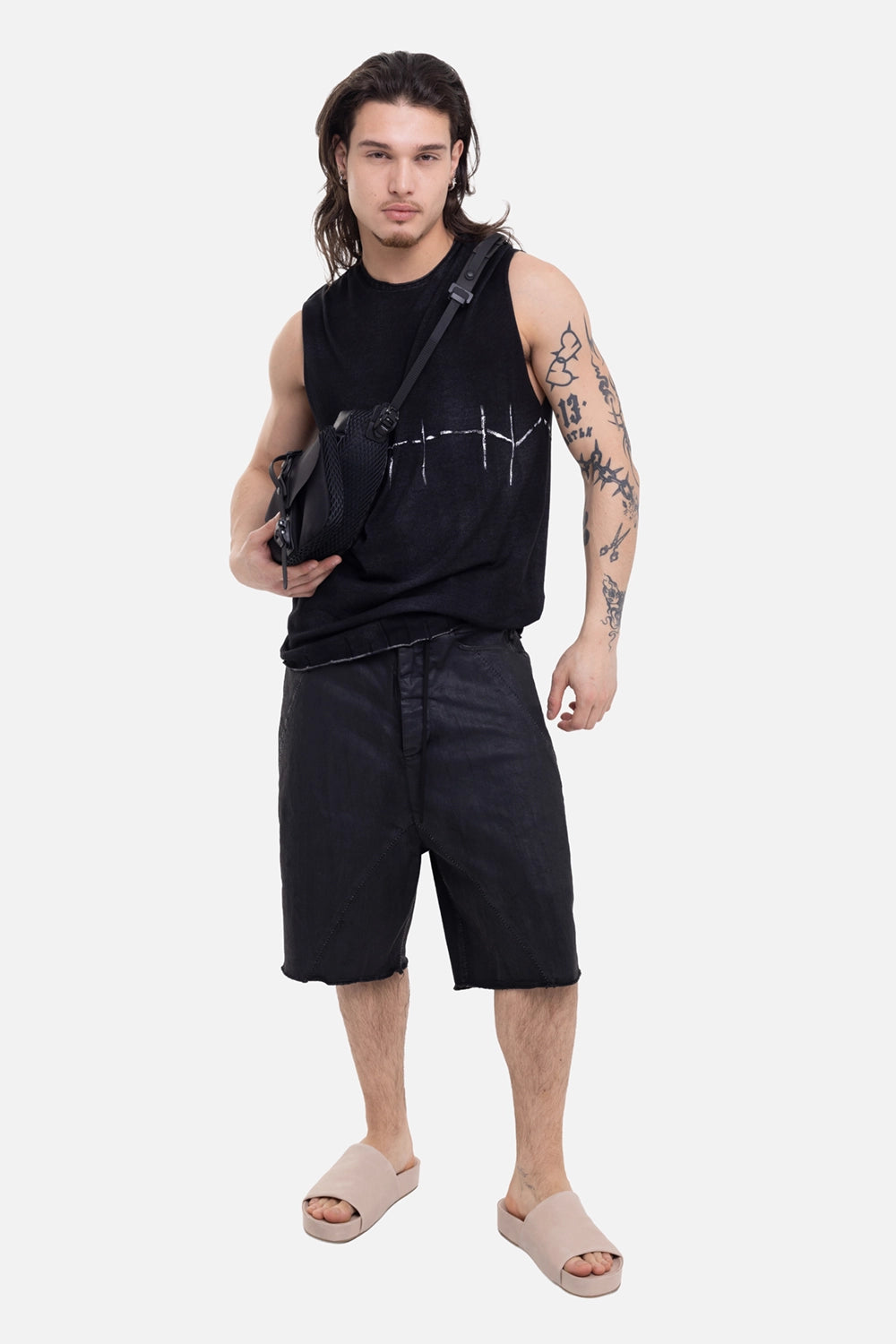 MD75 men's knit tank top in black, on-model full-length view, white barbed-wire graphic and raw hem