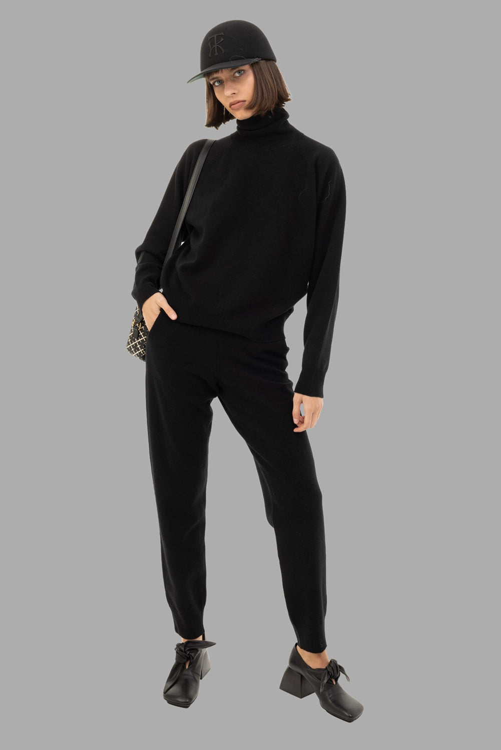 GentryPortofino women's knit trousers in Nero, full-length on model, pull-on waist and tapered leg.