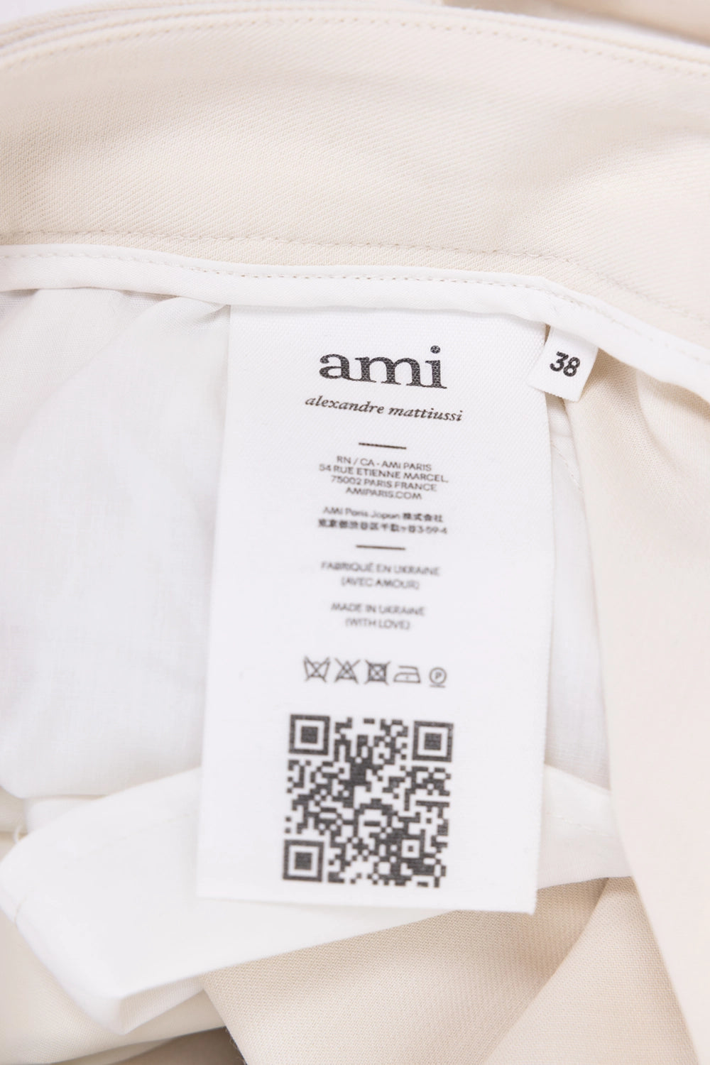 Pre-owned Ami women's layered wide-leg trousers in ivory, label close-up, ami alexandre mattiussi size tag