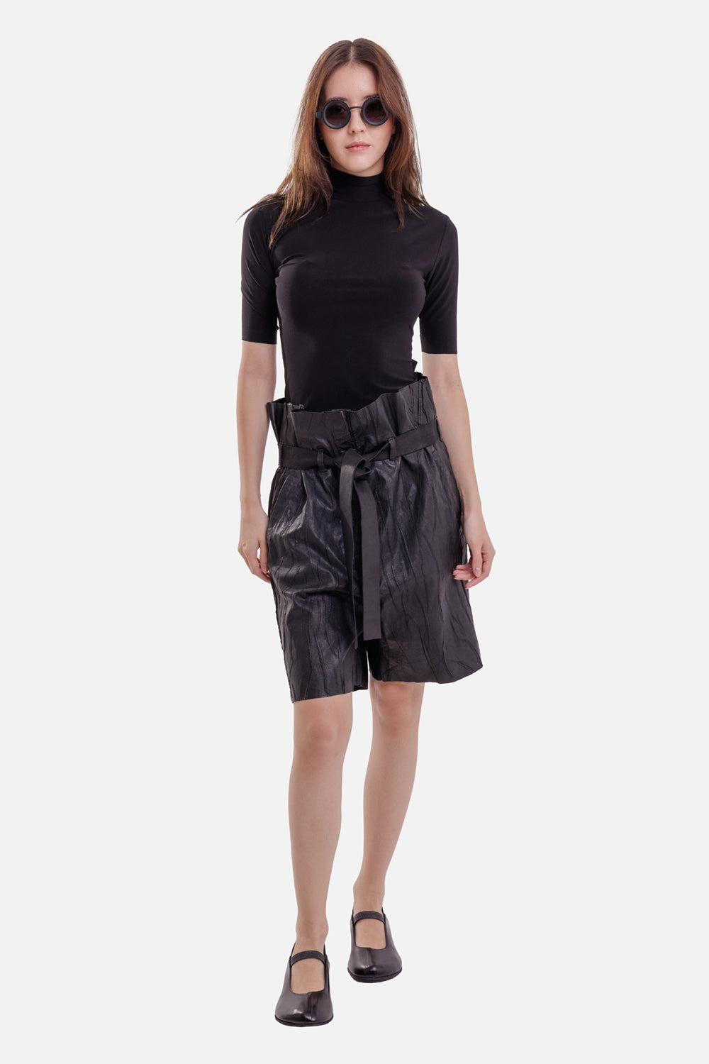Isaac Sellam Experience women's leather Bermuda shorts in Plomb, full-length view with paperbag waist and tie belt
