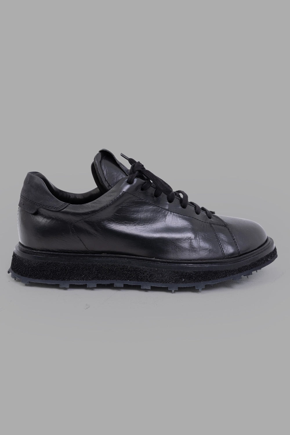 Shoto unisex leather low-top sneakers in black, side view, textured midsole and square-stud lug sole