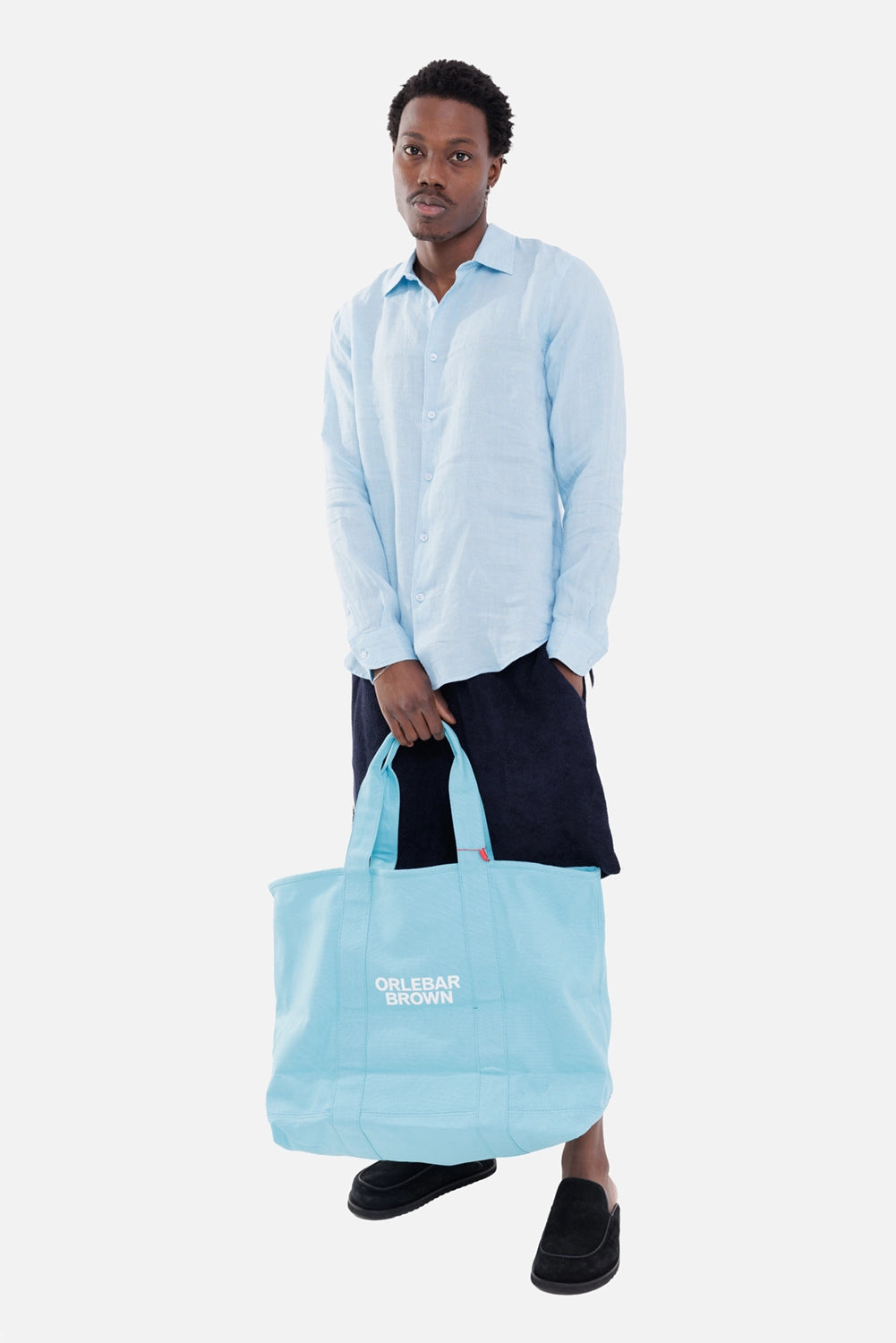 Orlebar Brown men's linen shirt in Riviera, on-model full length with button front and blue tote