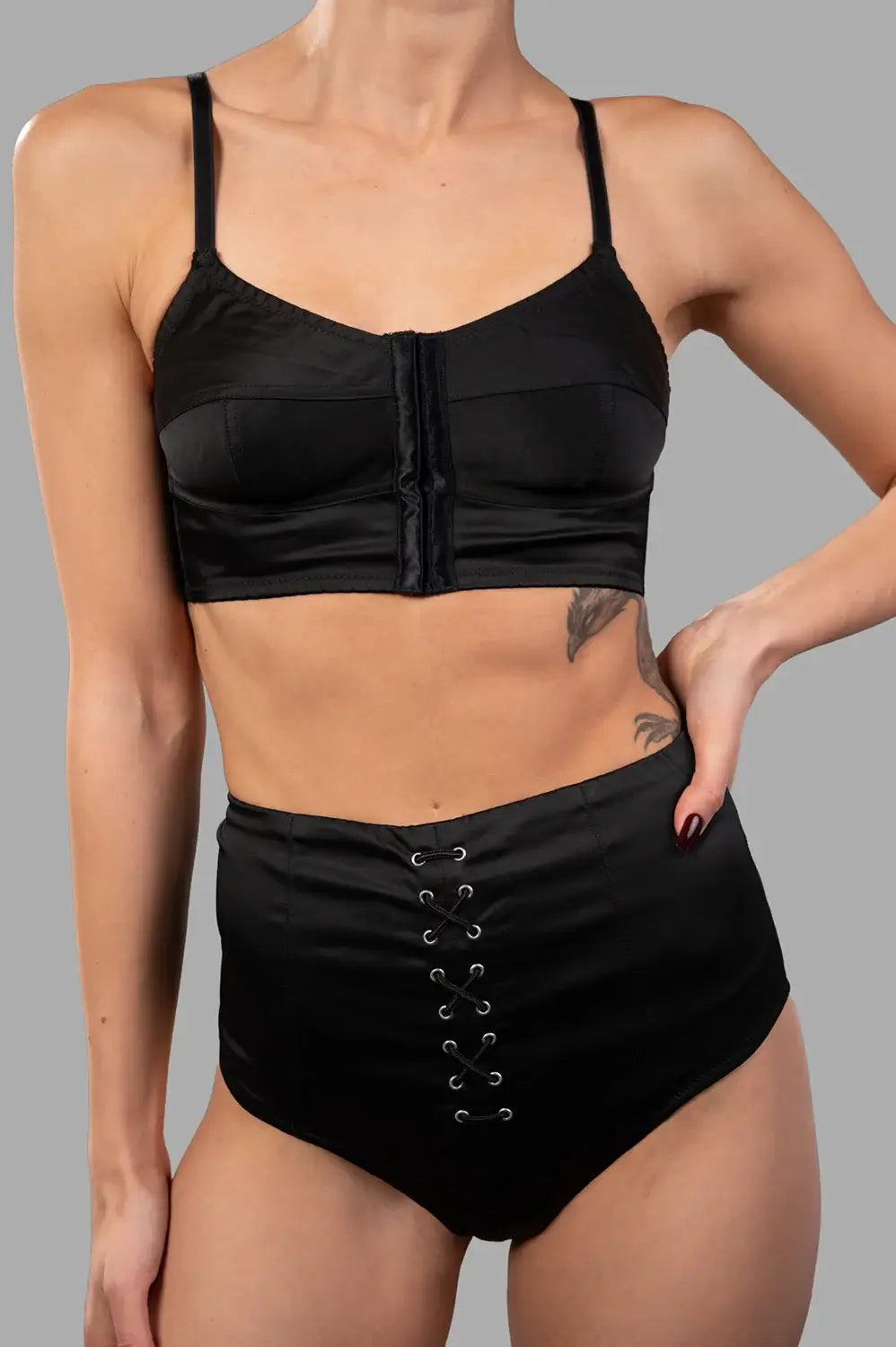 Sehnsucht Atelier lingerie set in black, front view of bralette with central closure and adjustable straps