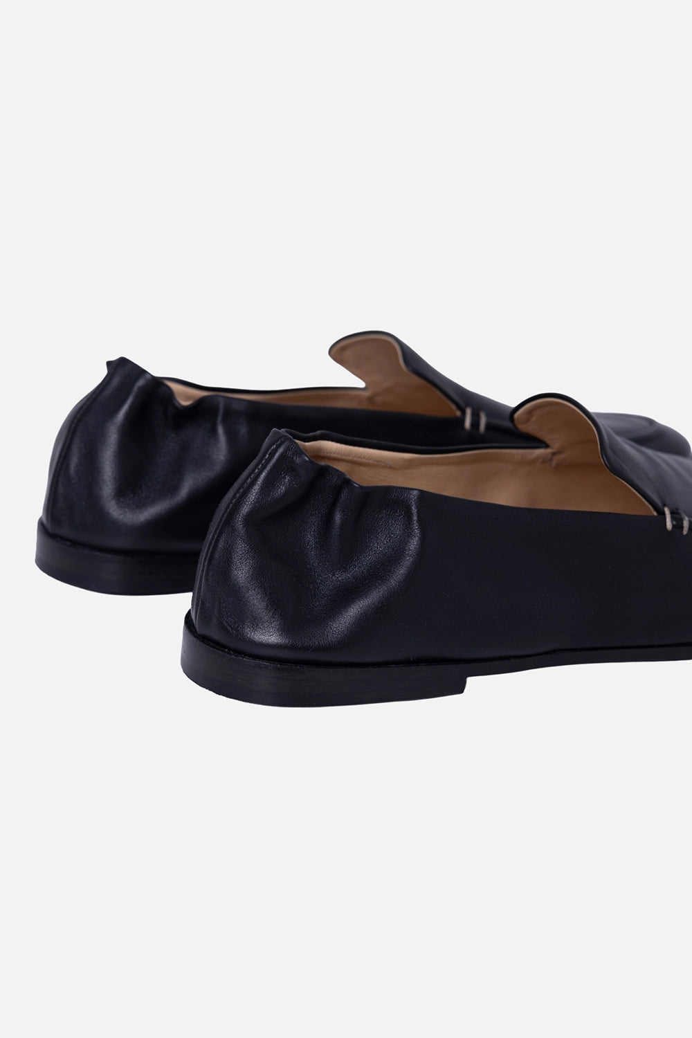 Marsèll men’s loafers in black, angled pair view, pebbled leather panels with smooth brown strap detail