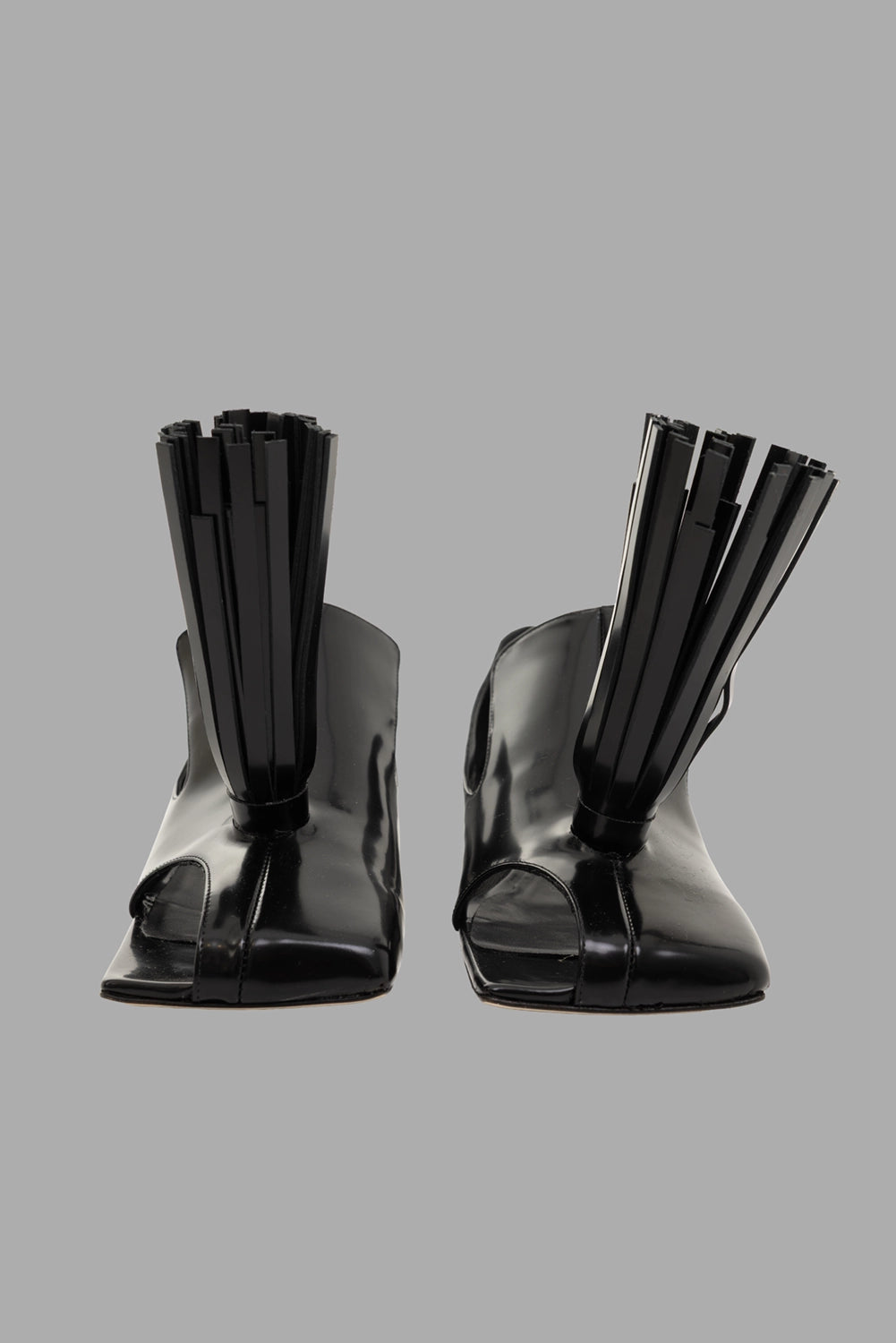 A.W.A.K.E. MODE women loafers in black, front view, open square toe with central seam and sculptural tassels.