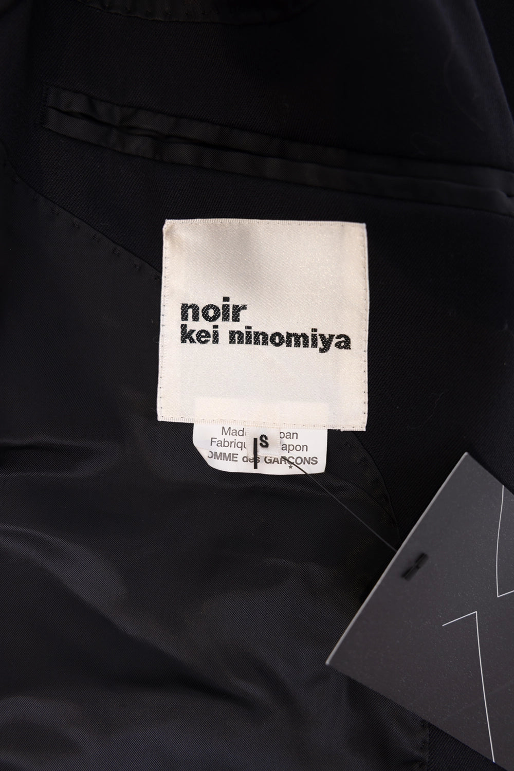 Pre-owned Noir Kei Ninomiya women's long coat in black, label close-up, woven logo tag and size S