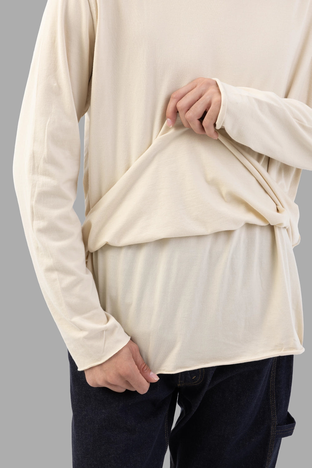 Attachment long-sleeve T-shirt in ecru, fabric close-up, layered hem showing inner panel
