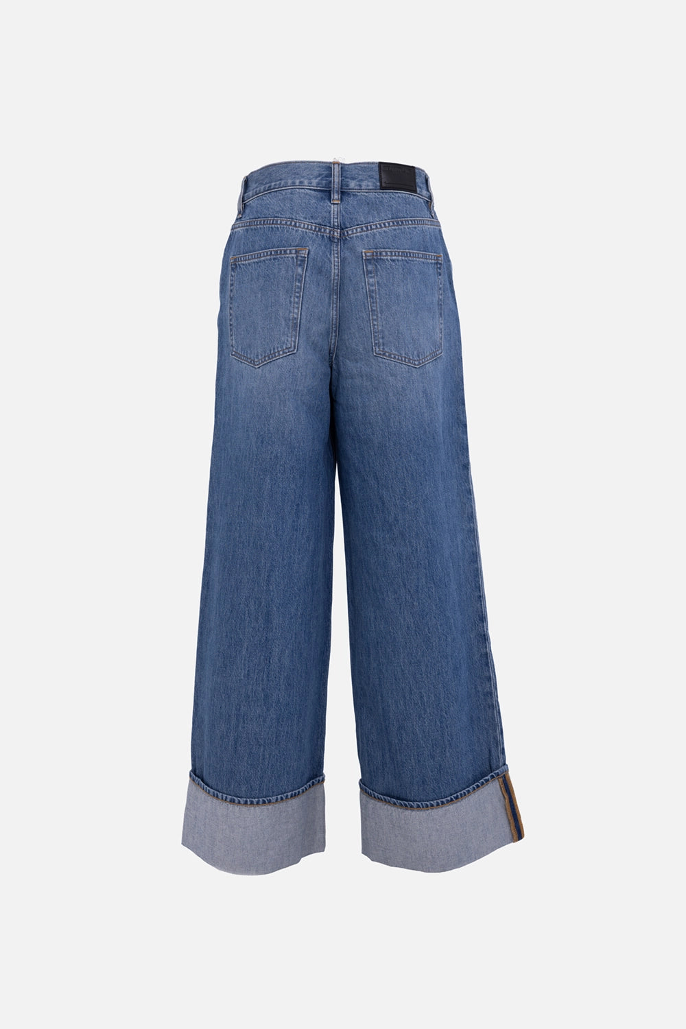 Helmut Lang low-rise drop jeans in classic blue, back view, leather logo patch at waistband and oversized cuffs