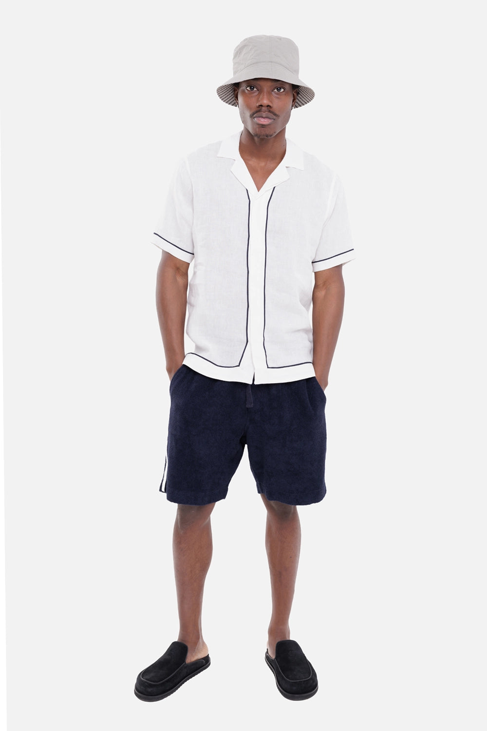 Orlebar Brown men's linen shirt in White Sand/Night Iris, on-model full-length view with short sleeves and navy piping