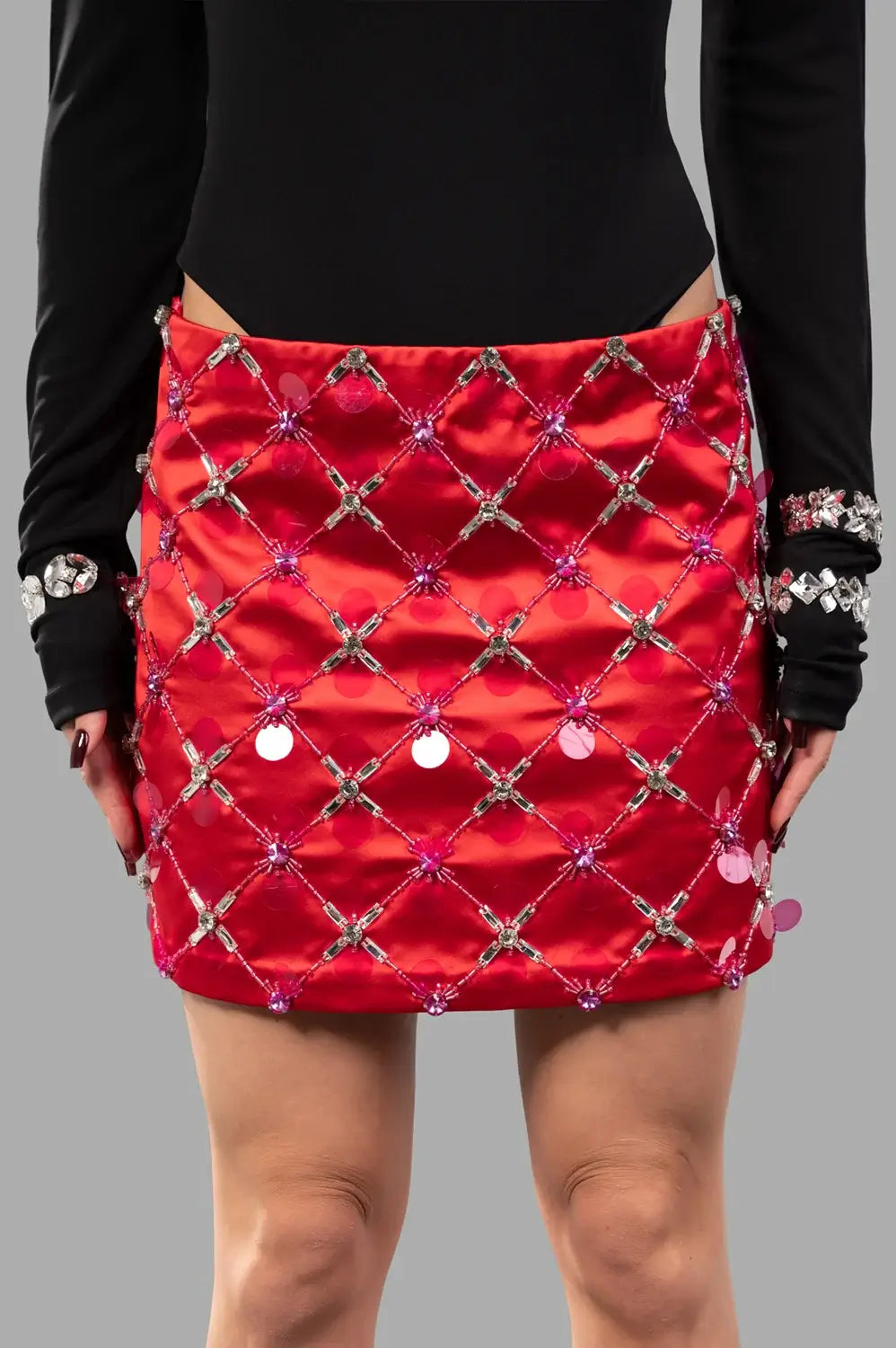 front close-up of red satin micro skirt with crystal lattice beading and sequins