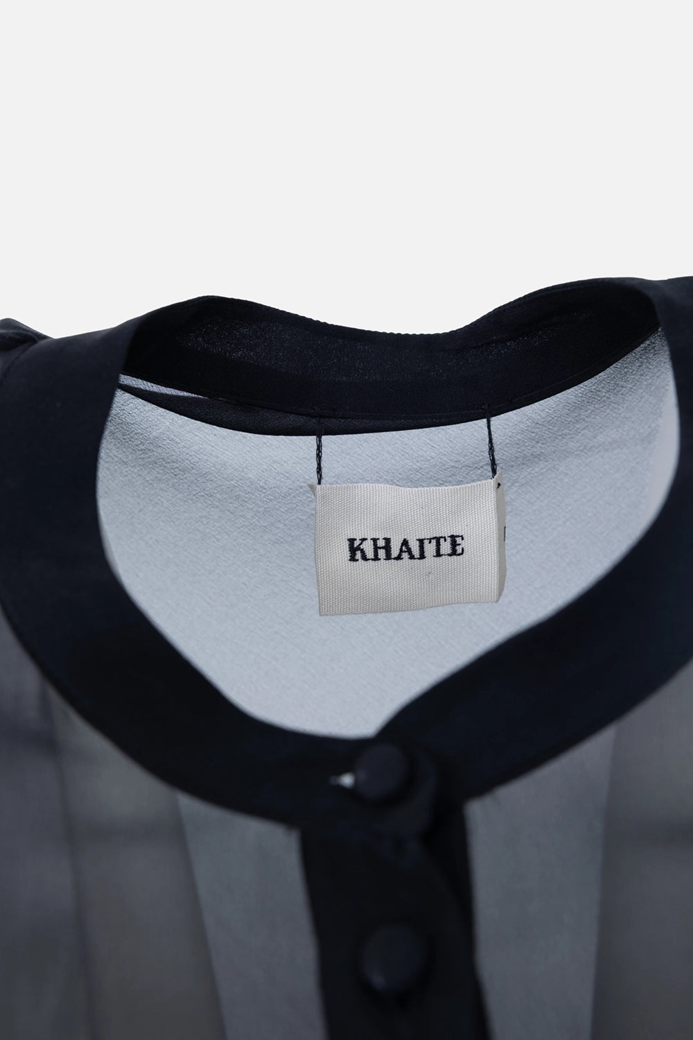 Pre-owned Khaite mini dress in black, label close-up, sheer neckline binding
