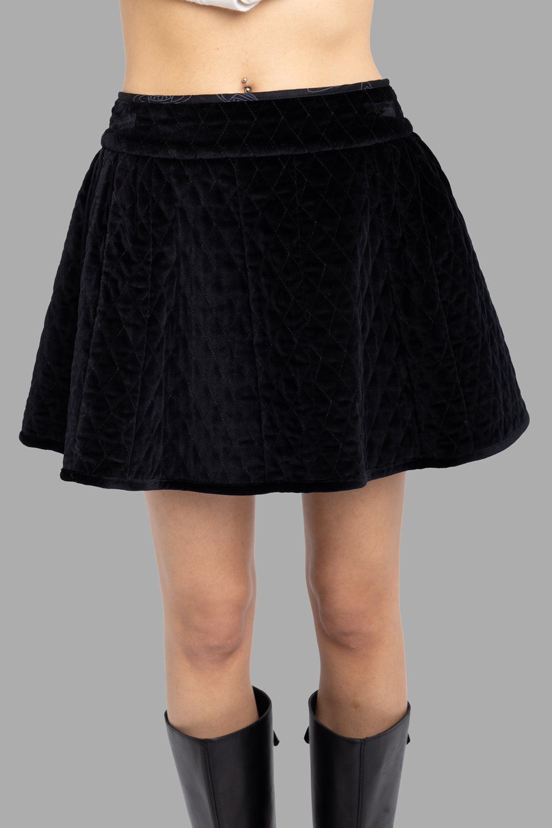 Vivienne Westwood women's black quilted velvet mini skirt, front view, diamond quilting and clean waistband.