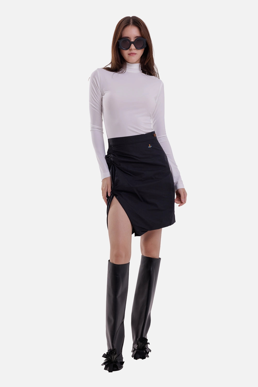 Vivienne Westwood women's black mini skirt, on-model full-length view with high waist and ruched side slit