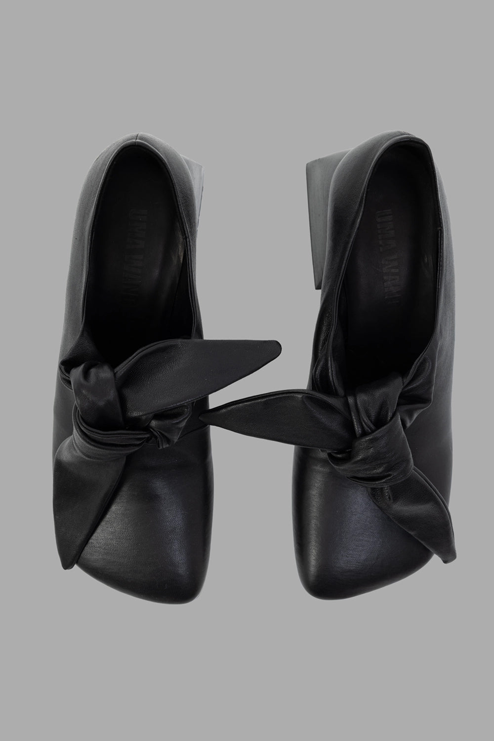 Uma Wang women mules in black, top view, oversized knot at vamp and structured square toe.