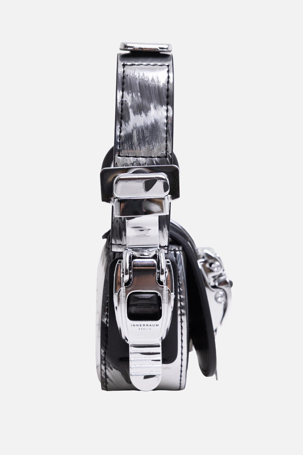 Innerraum women's nano bag in distressed silver, hardware close-up with side clasp, black ring and curved handle