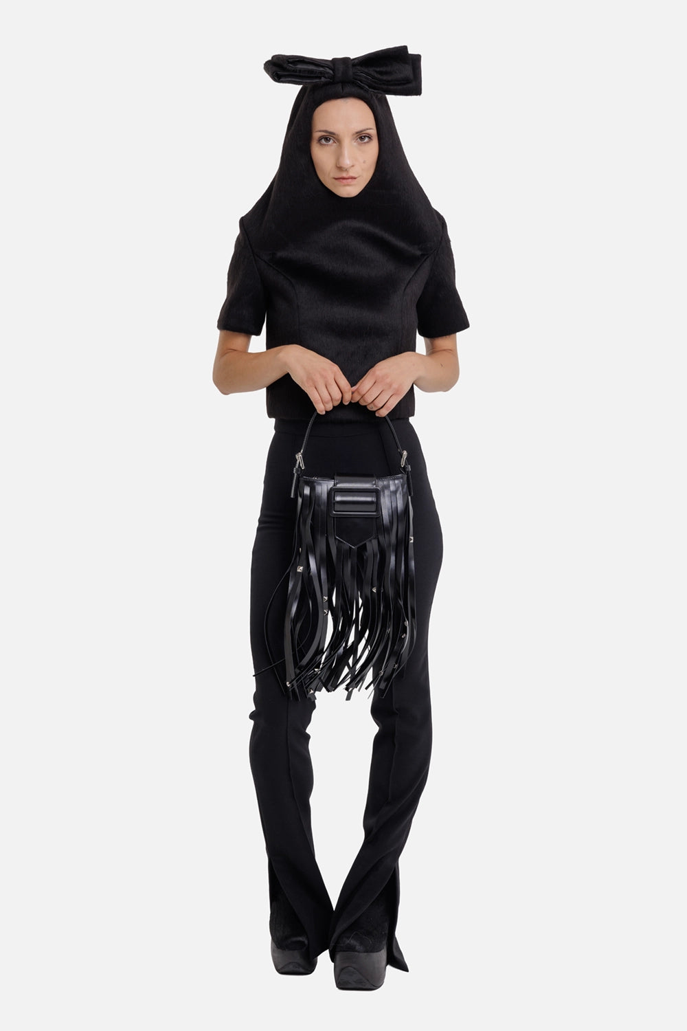 Vaquera women's black bow top, full-length model view with oversized hood bow and short sleeves
