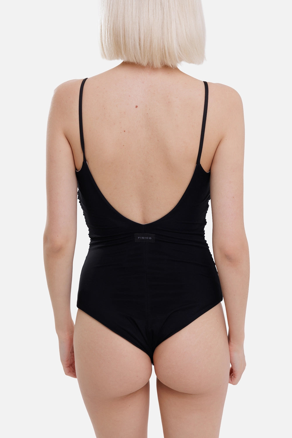 Fisico women's one-piece swimsuit in black and sand, back view, deep V back and small logo label