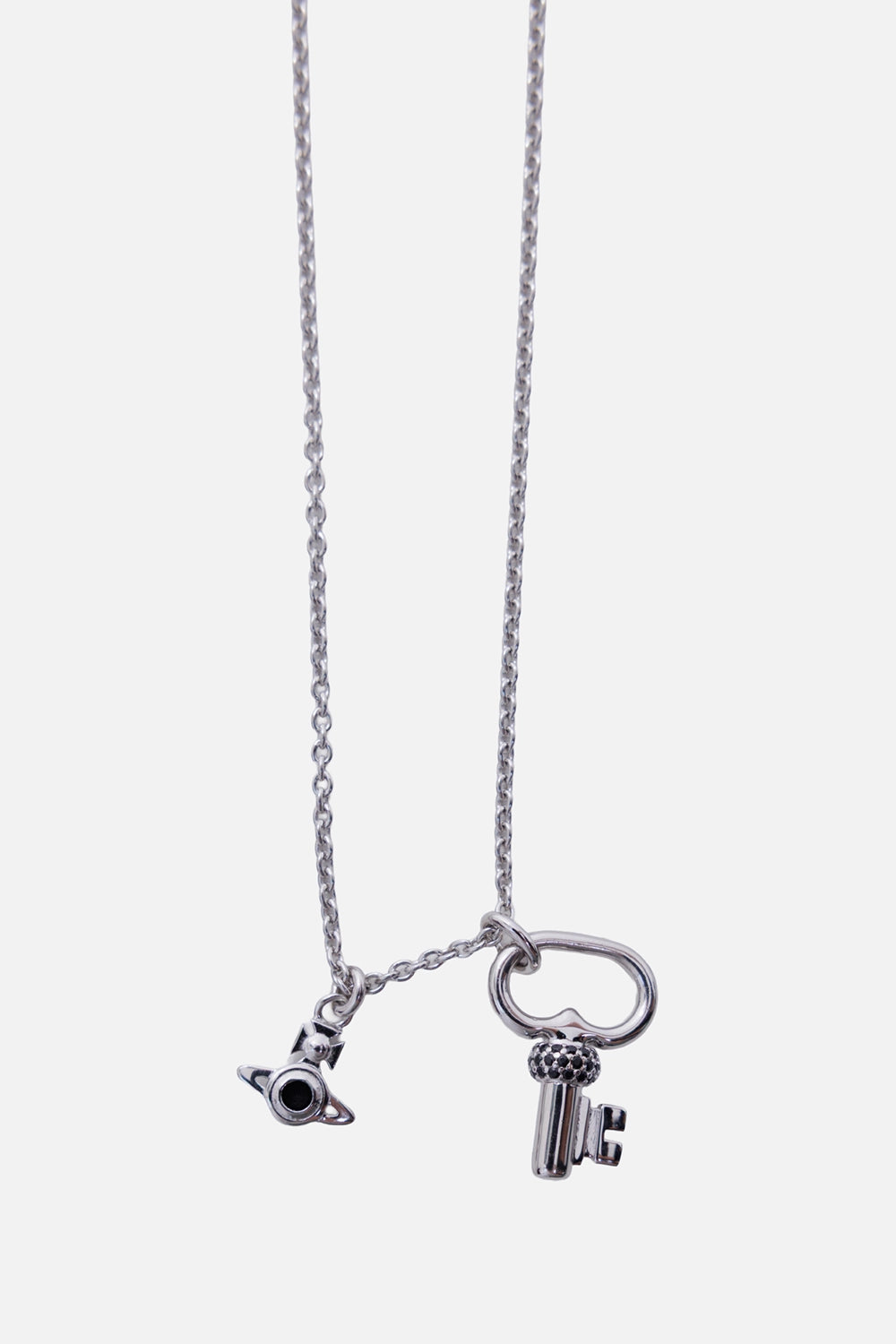 Vivienne Westwood men's Ovidio necklace in platinum tone, pendant close-up with black pavé key and Orb charm