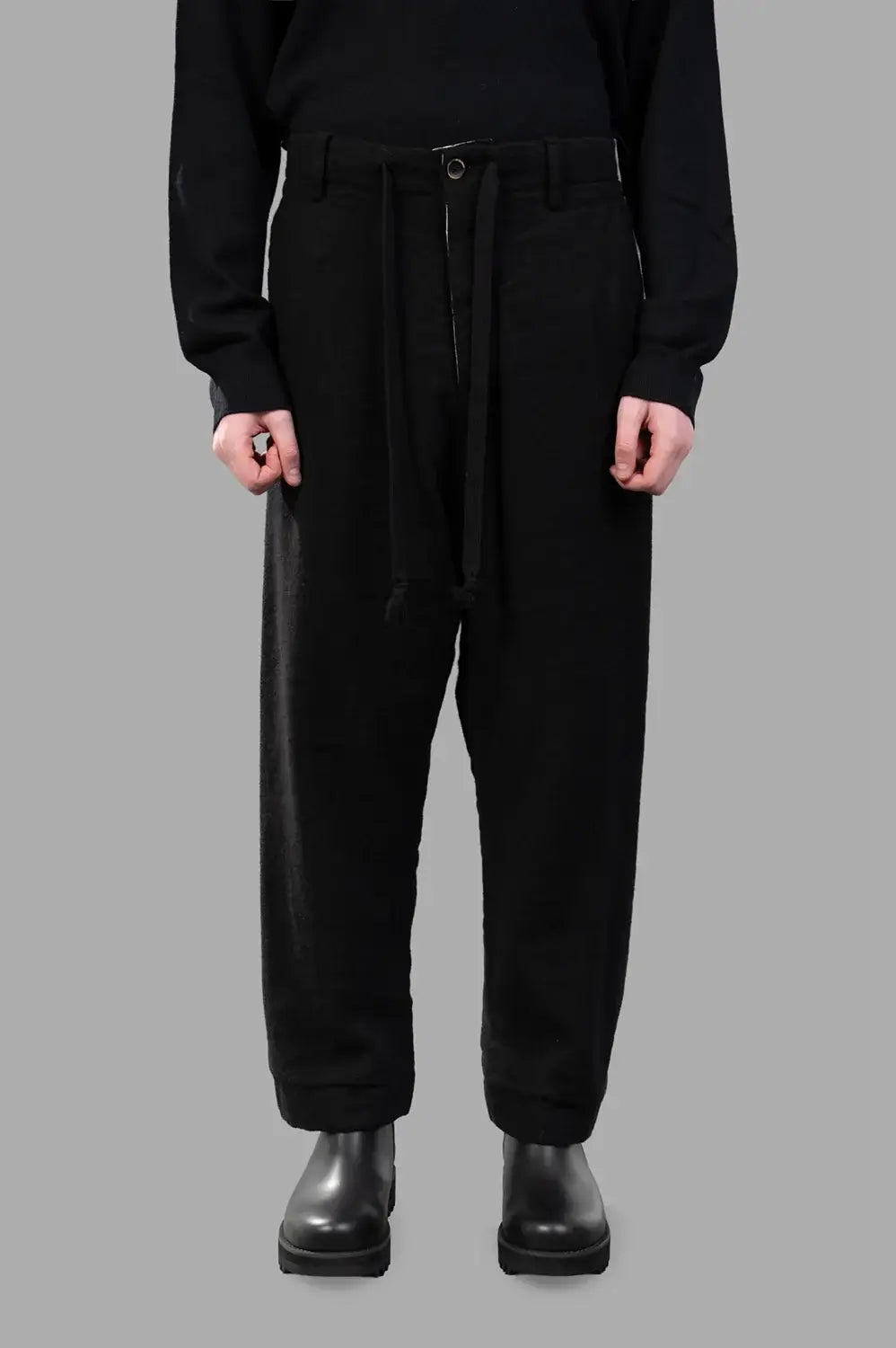 UMA WANG pants in black, front view, drawstring waist and front button detail