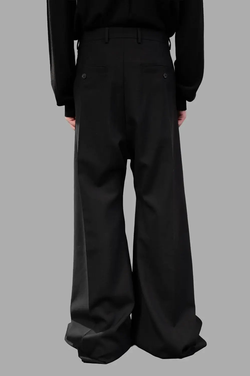 Rick Owens wide-leg pants in black wool‑blend, back view, creased legs and belt loops