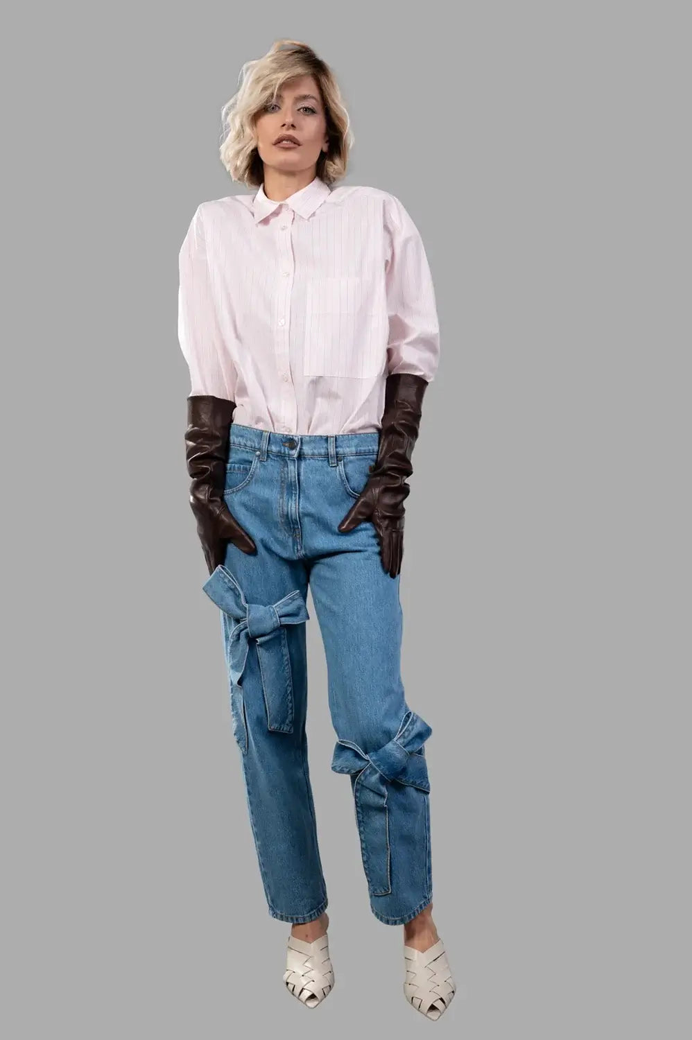 MSGM pants in blue washed denim, on‑model full length, stonewashed texture and logo embroidery on side
