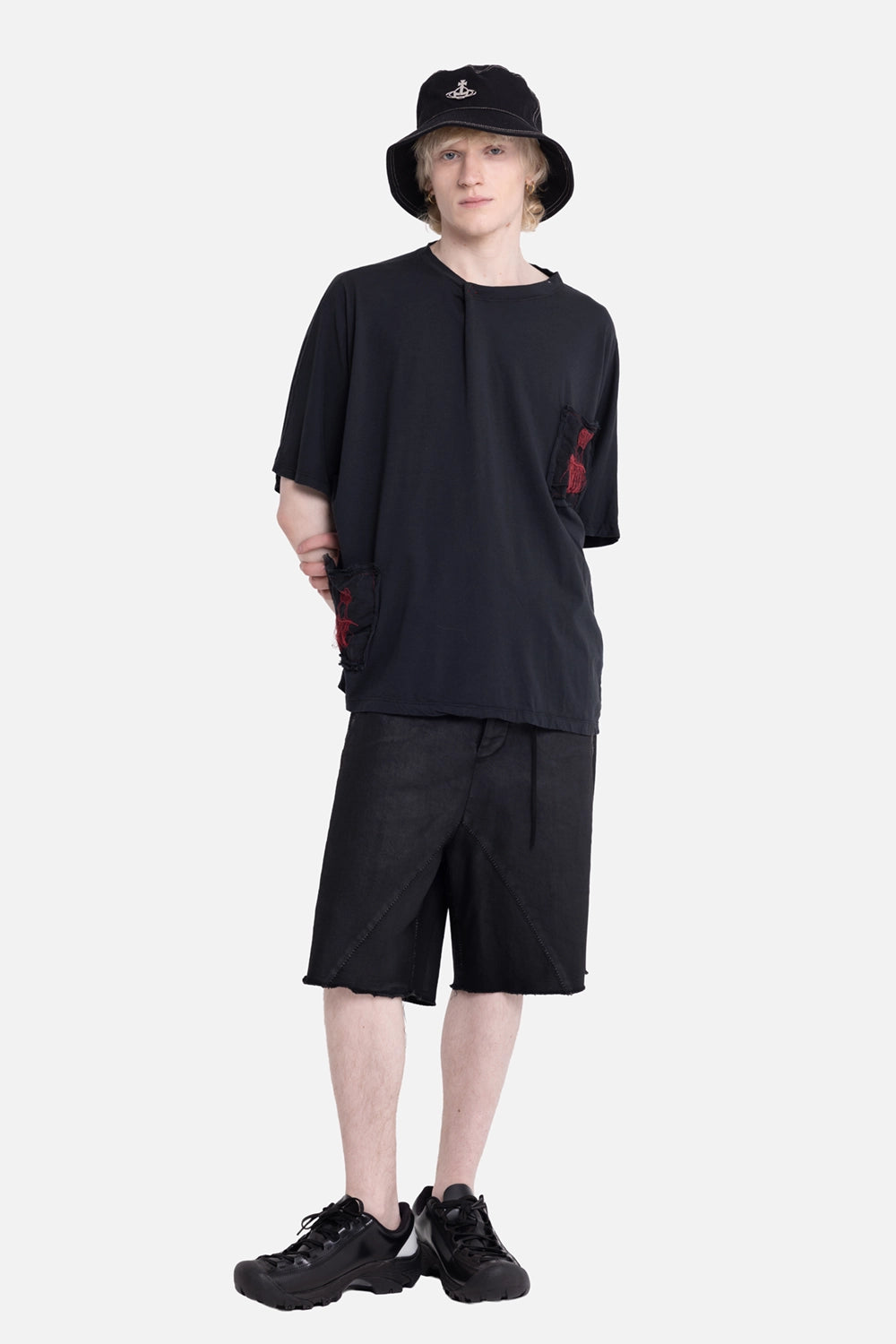 Vuscichè men's patched T-shirt in black, on-model full-length, red stitched patches and raw neck