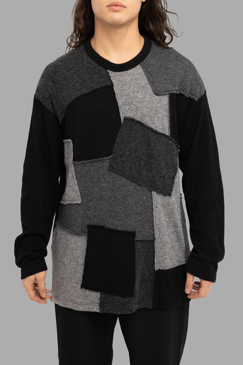Comme des Garçons Homme men’s patchwork sweater in black/grey, front view, raw-edge square panels and crew neckline