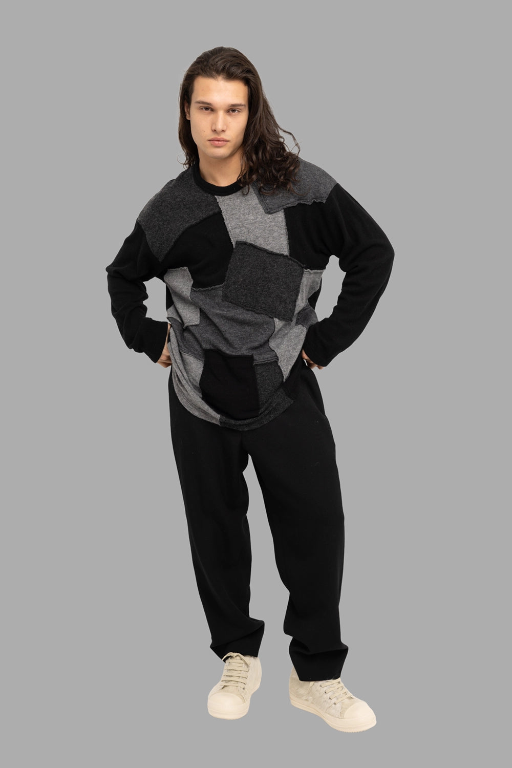 Comme des Garçons Homme men’s patchwork sweater in black/grey, on-model full length, crewneck and raw-edge panels