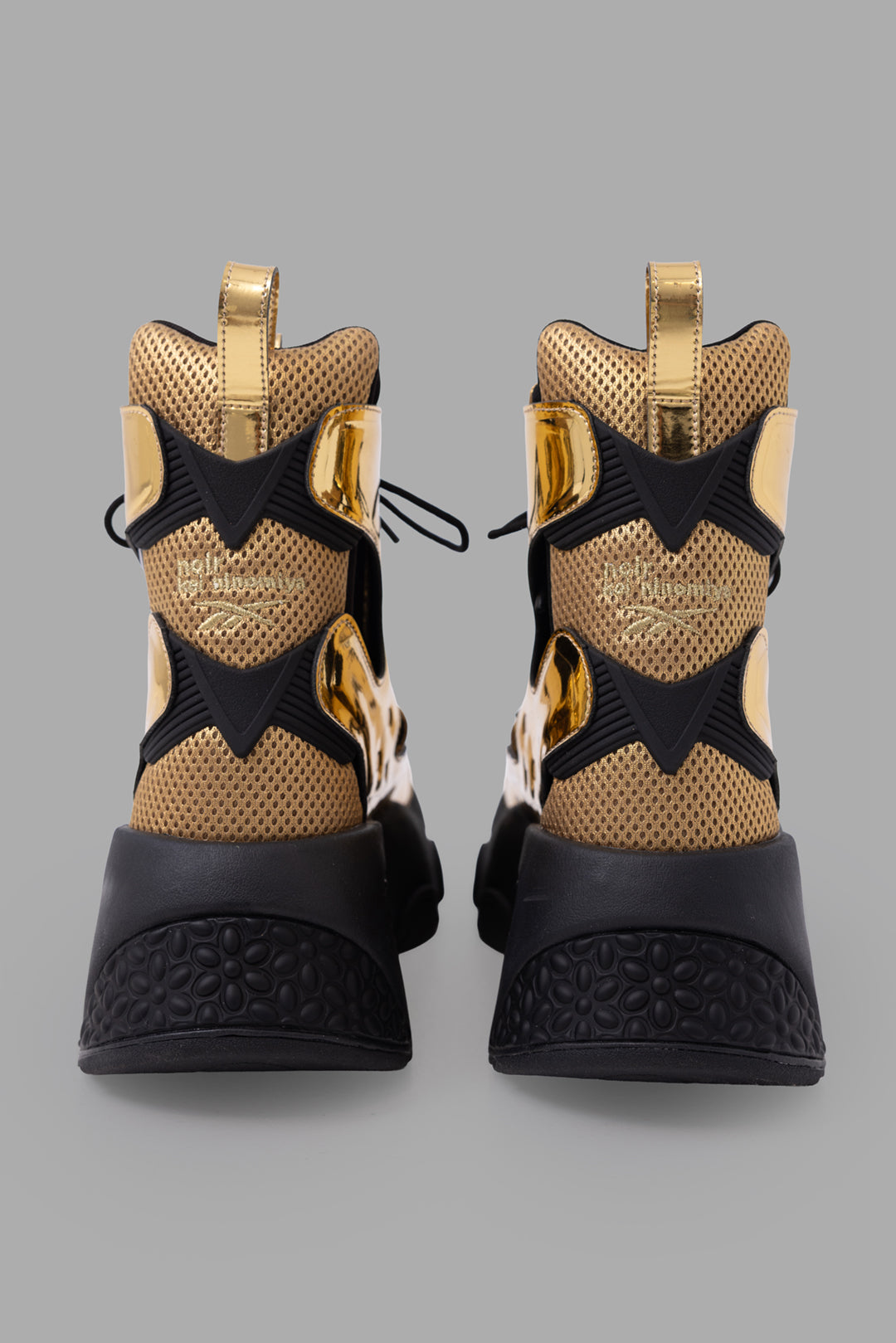 Noir Kei Ninomiya x Reebok unisex gold cutout platform boots, back view showing mesh heel and embossed logo