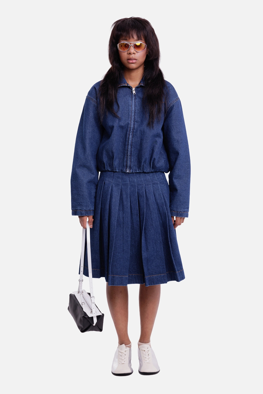 MSGM women's dark blue denim midi skirt, full-length model view with wide pleats and knee-length hem