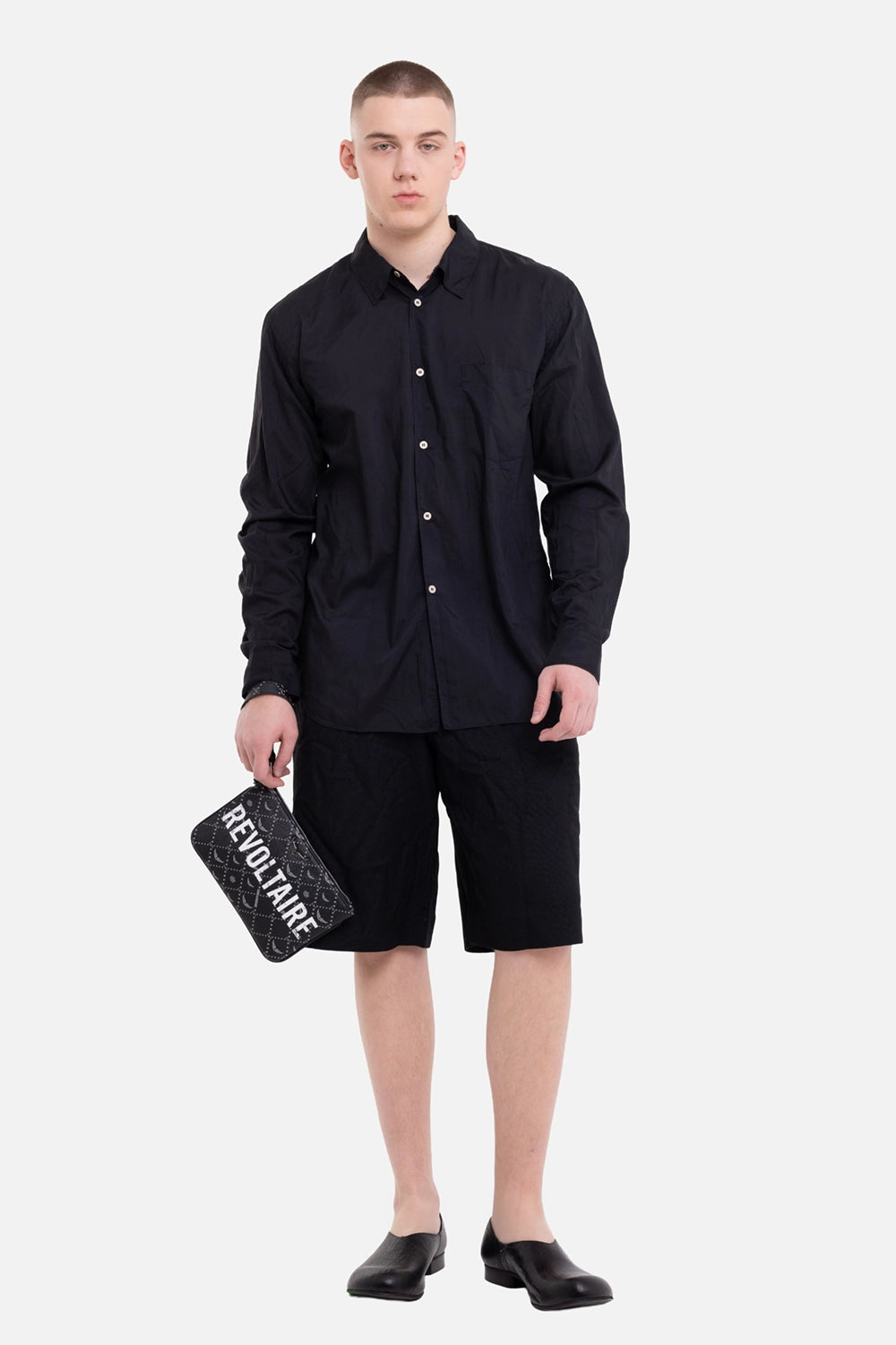 Comme des Garçons Homme Deux men's black shorts, on-model full-length view, straight leg and knee-length cut