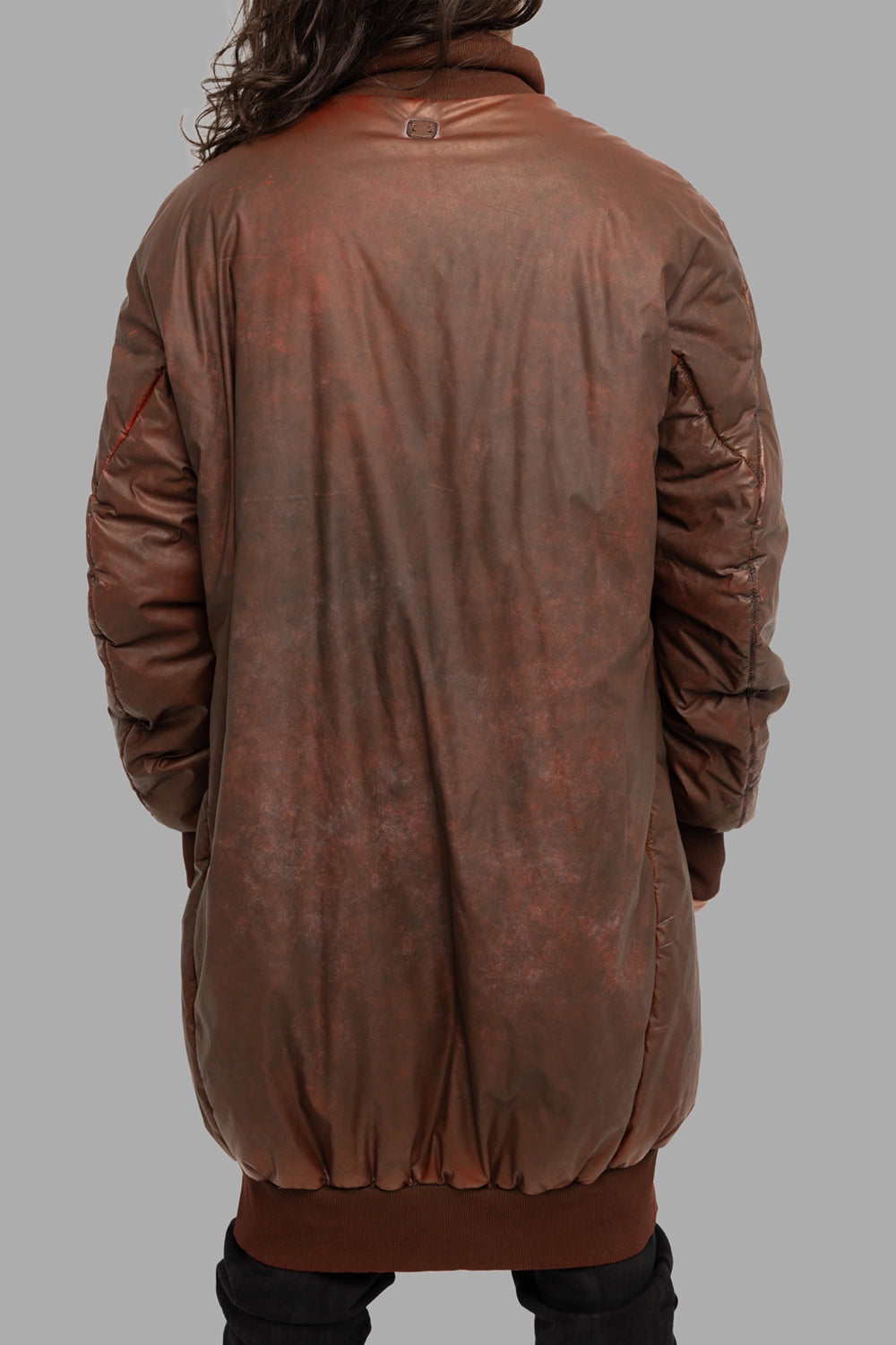 69 by Isaac Sellam men’s puffer coat in Dirty Red, back view, signature stapled metal tab at neck