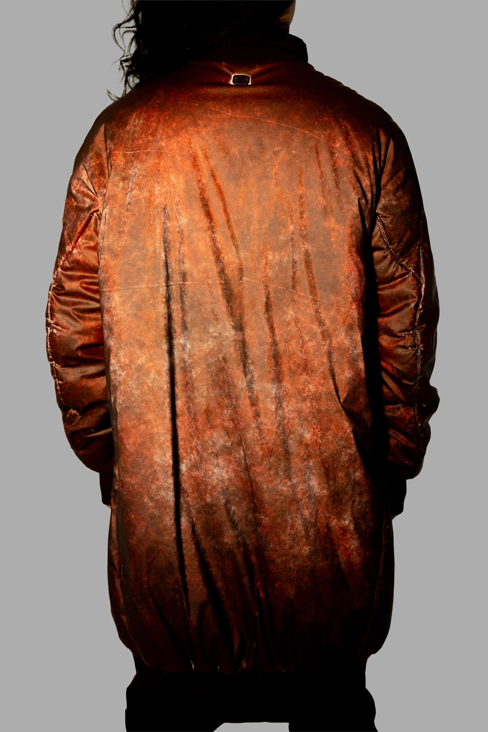 69 by Isaac Sellam men’s puffer coat in Dirty Red, back view, balloon hem and sculpted quilting