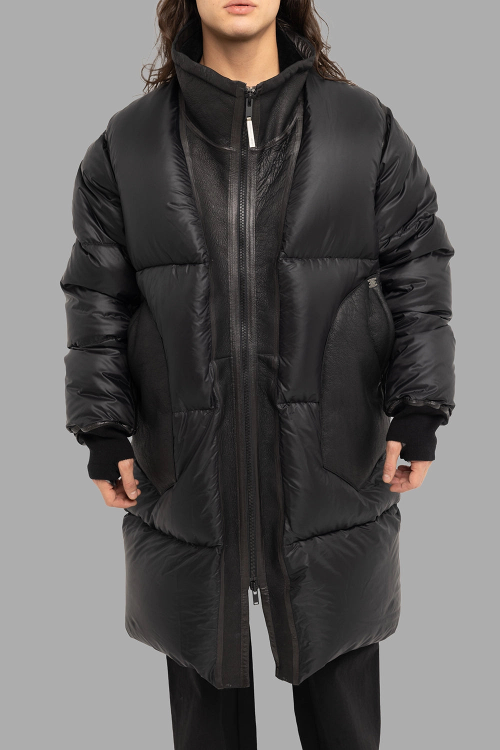Isaac Sellam Experience unisex puffer coat in noir, front view, two-way zipper and leather panels at pockets