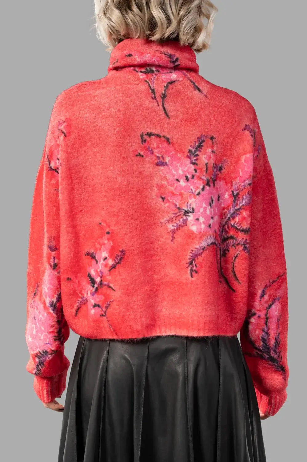 back close-up of rubis/rose pullover showing rolled turtleneck, rib hem and allover floral artwork