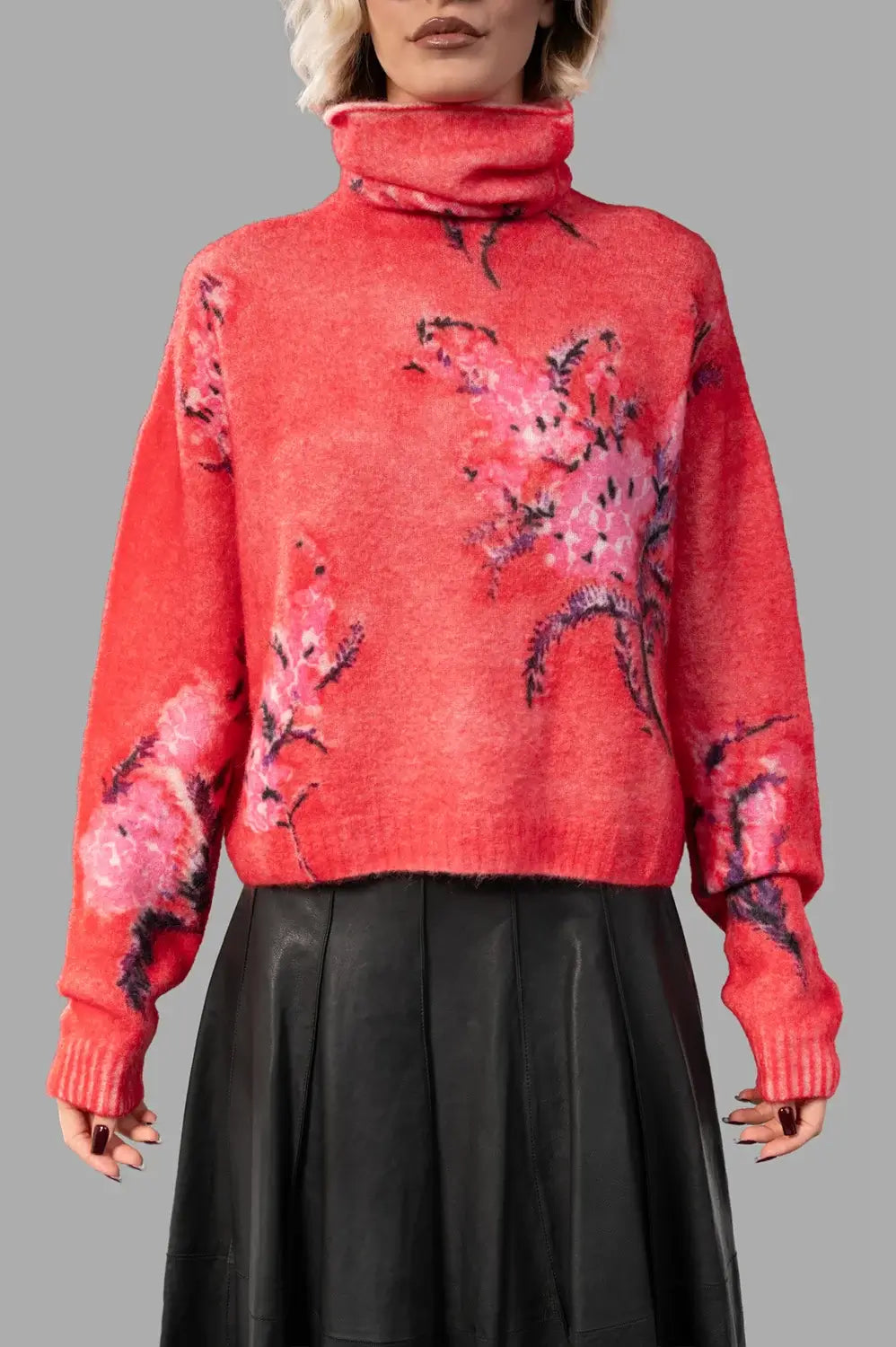front close-up of rubis/rose turtleneck pullover with handpainted floral motif and soft knit texture