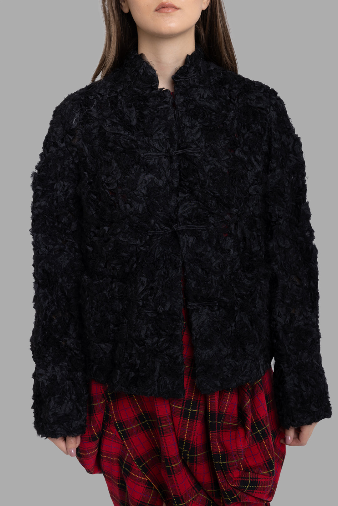 Comme des Garçons women's black ruffled mesh jacket, front view showing knot closures and dense floral texture.