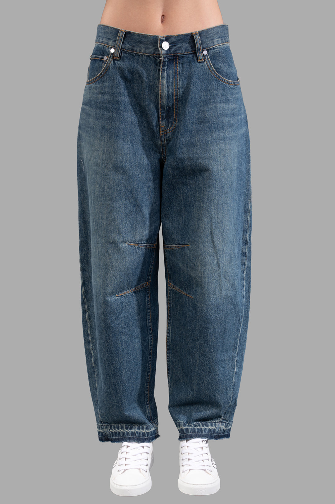 Helmut Lang Cocoon Jeans in vintage blue wash, featuring barrel-leg silhouette and unique released hem detail.