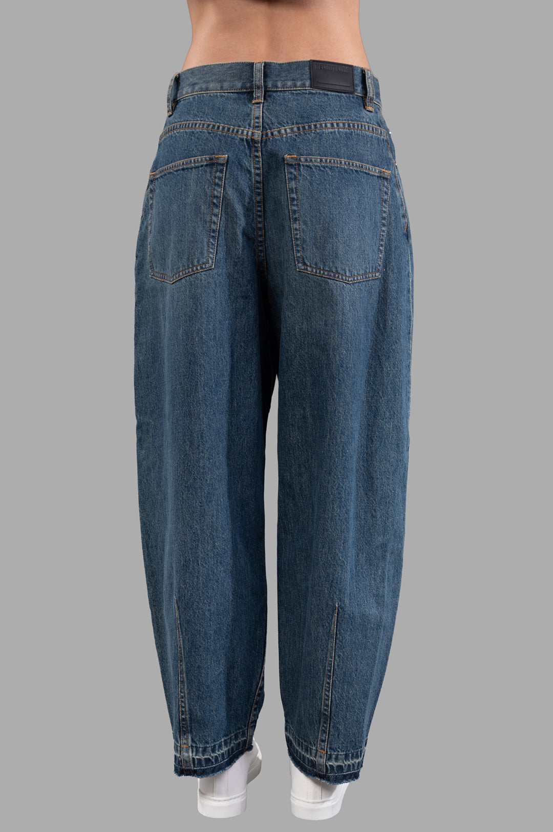 Helmut Lang Cocoon Jeans in vintage wash, showing barrel-leg design with sculpted darts and released hem, back view.