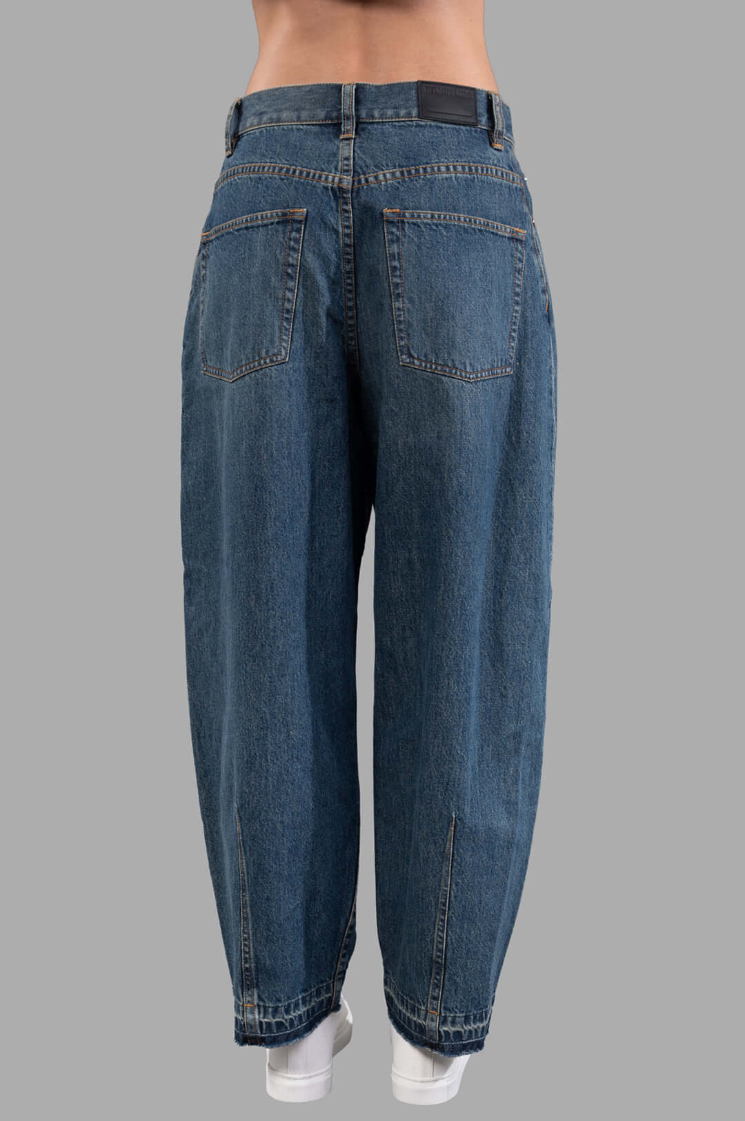 Helmut Lang Cocoon Jeans in vintage wash, showing barrel-leg design with sculpted darts and released hem, back view.