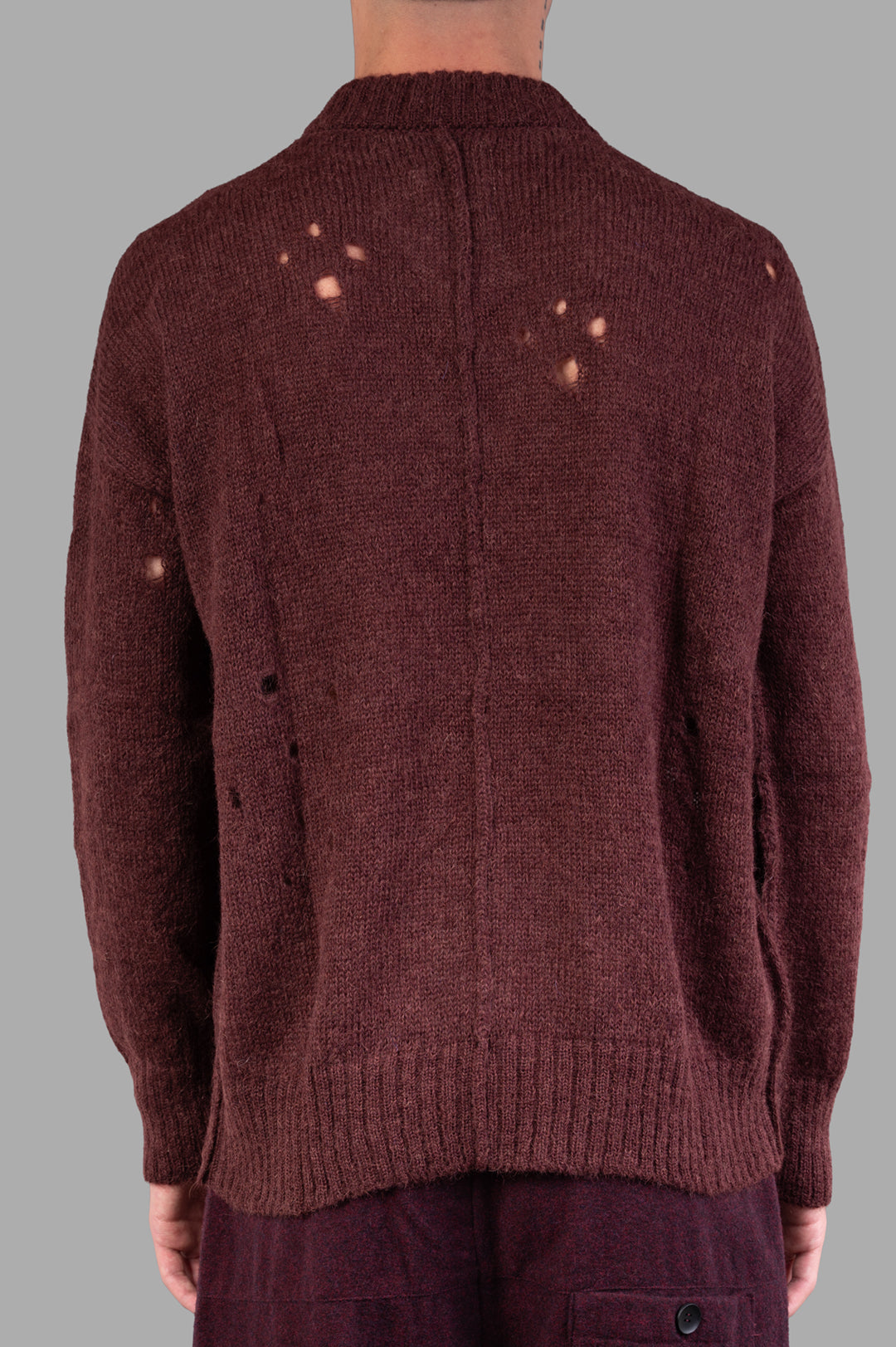 Marc Point Rusty Red Sweater shown from the back, featuring a distressed design, ribbed hem, and cozy texture.