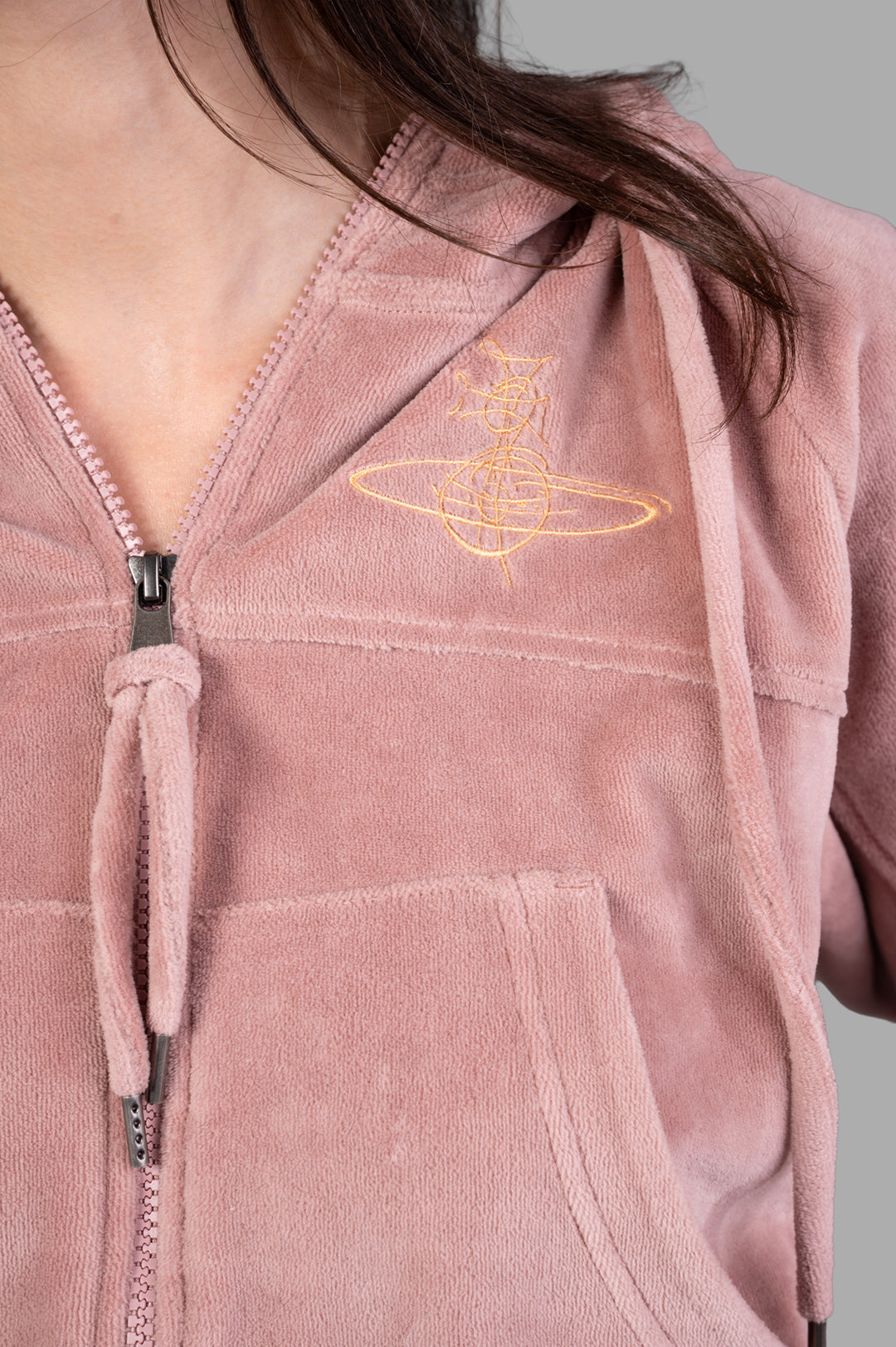 Vivienne Westwood Velvet Zip-up Hoodie featuring a close-up of embroidery, zipper, and soft pink velvet texture.