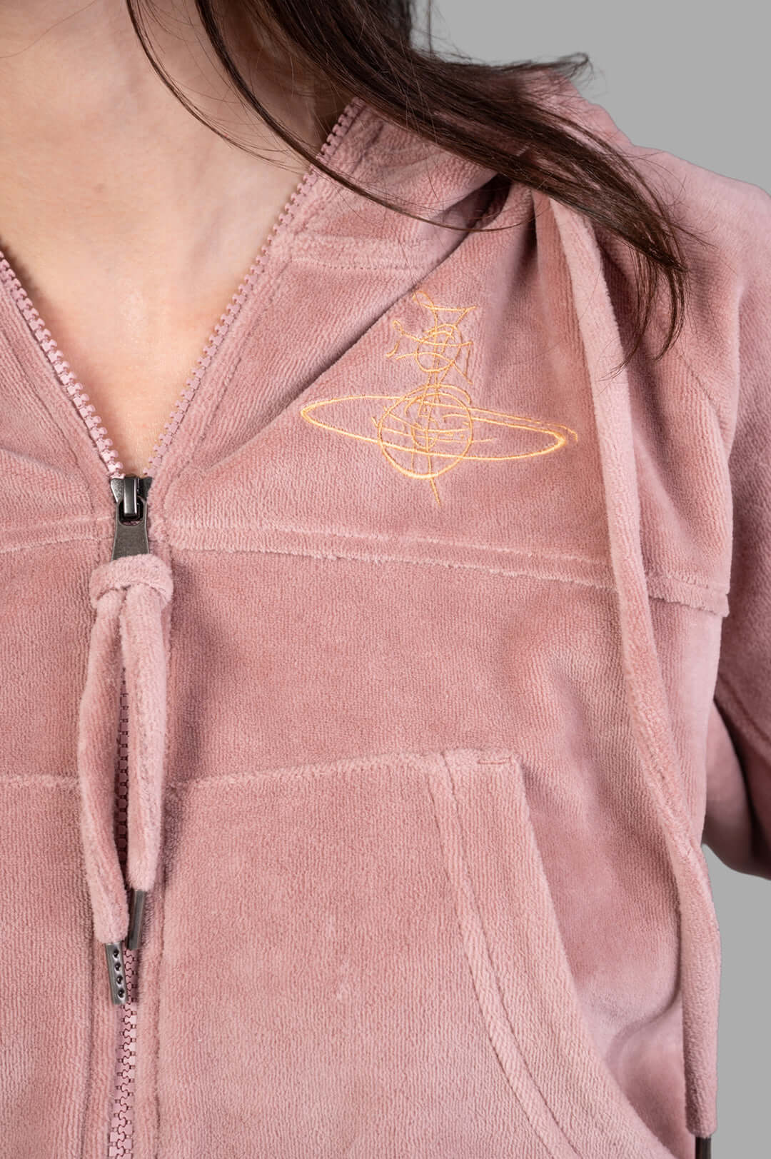 Vivienne Westwood Velvet Zip-up Hoodie featuring a close-up of embroidery, zipper, and soft pink velvet texture.