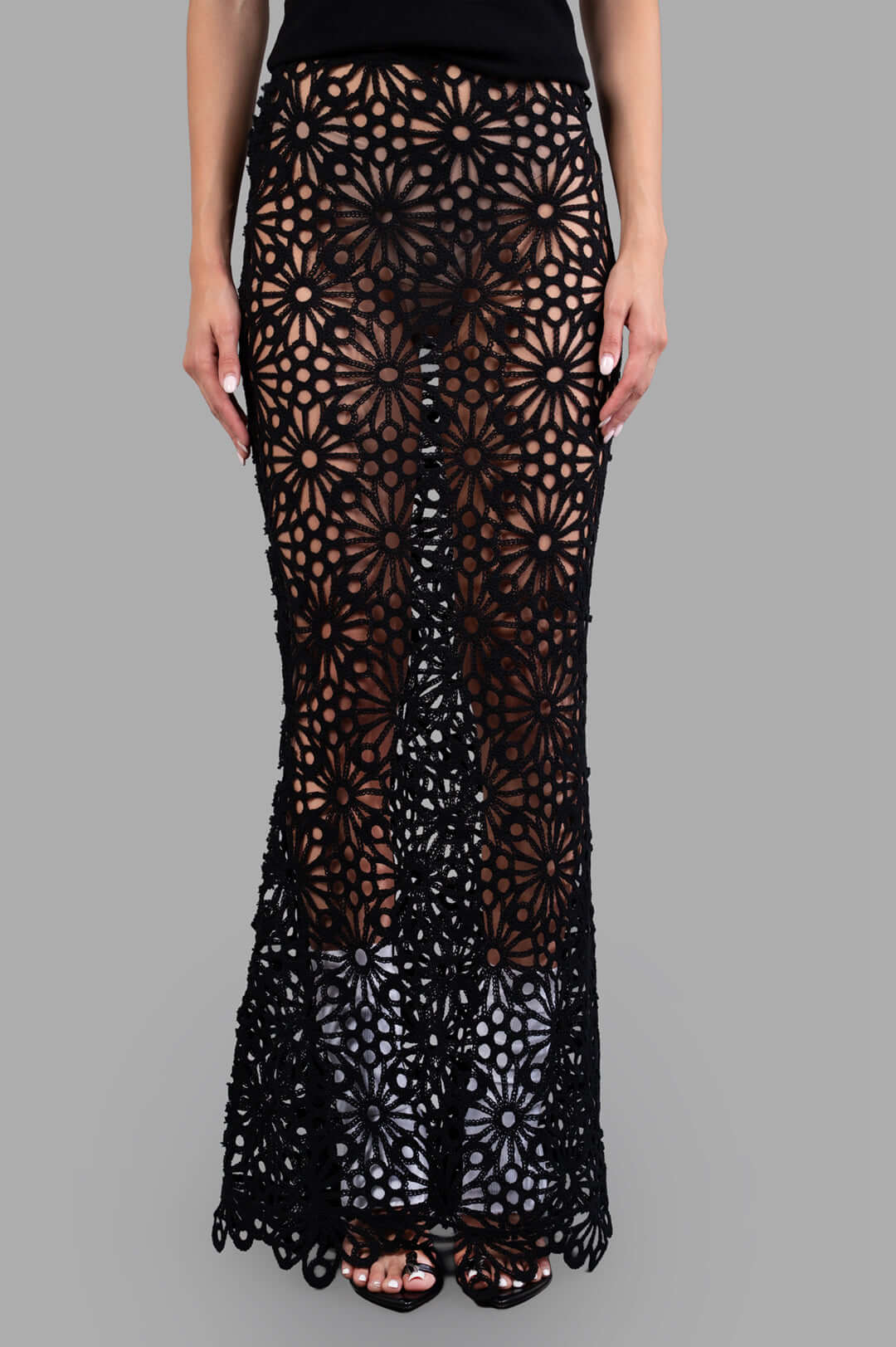 Norma Kamali Obie Long Skirt in black, showcasing sheer floral fabric and fishtail hem on model. Elastic waist for a.