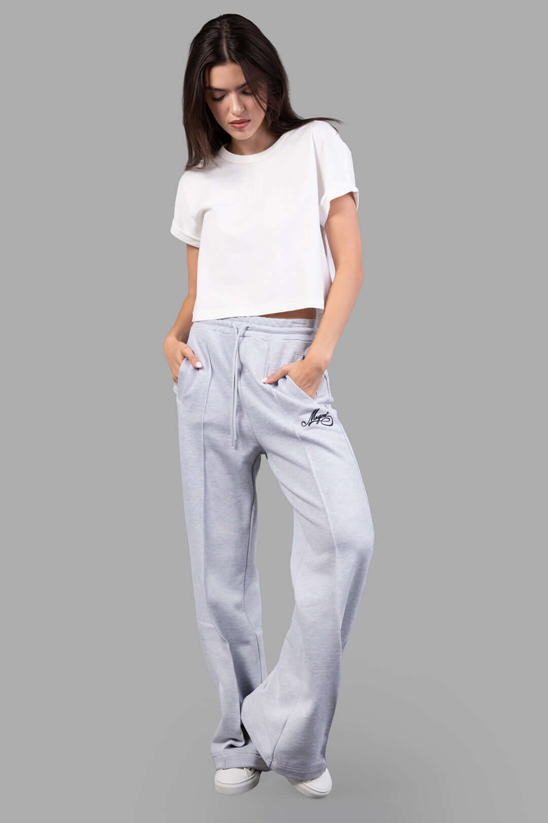 MSGM grey Logo Track Pants on-model front view, featuring embroidered logo, elastic waistband, and drawstring for comfort.