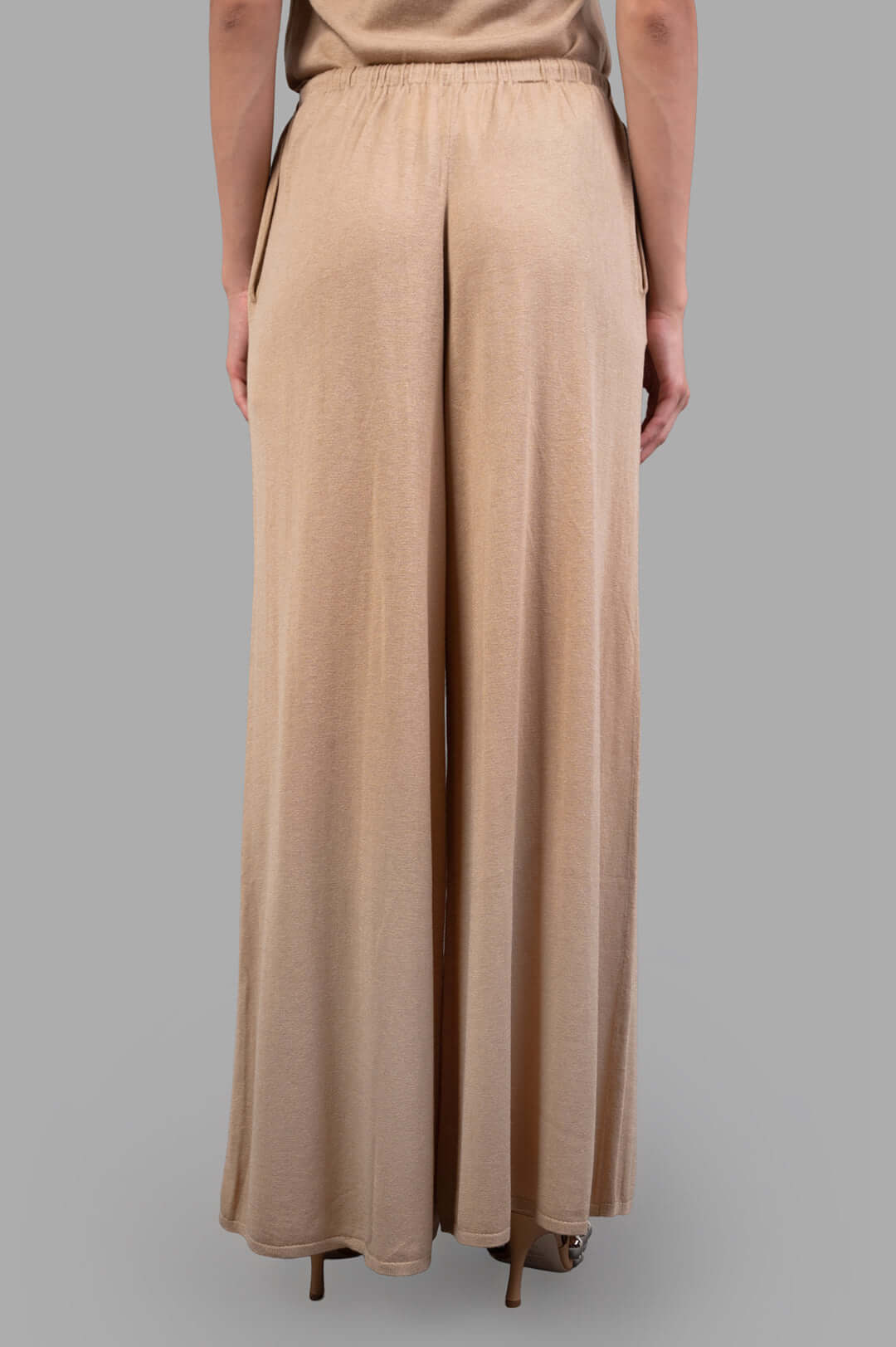 By Malene Birger Drawstring Trousers, beige, featuring wide legs, loose silhouette, and adjustable tie waist viewed from the back.