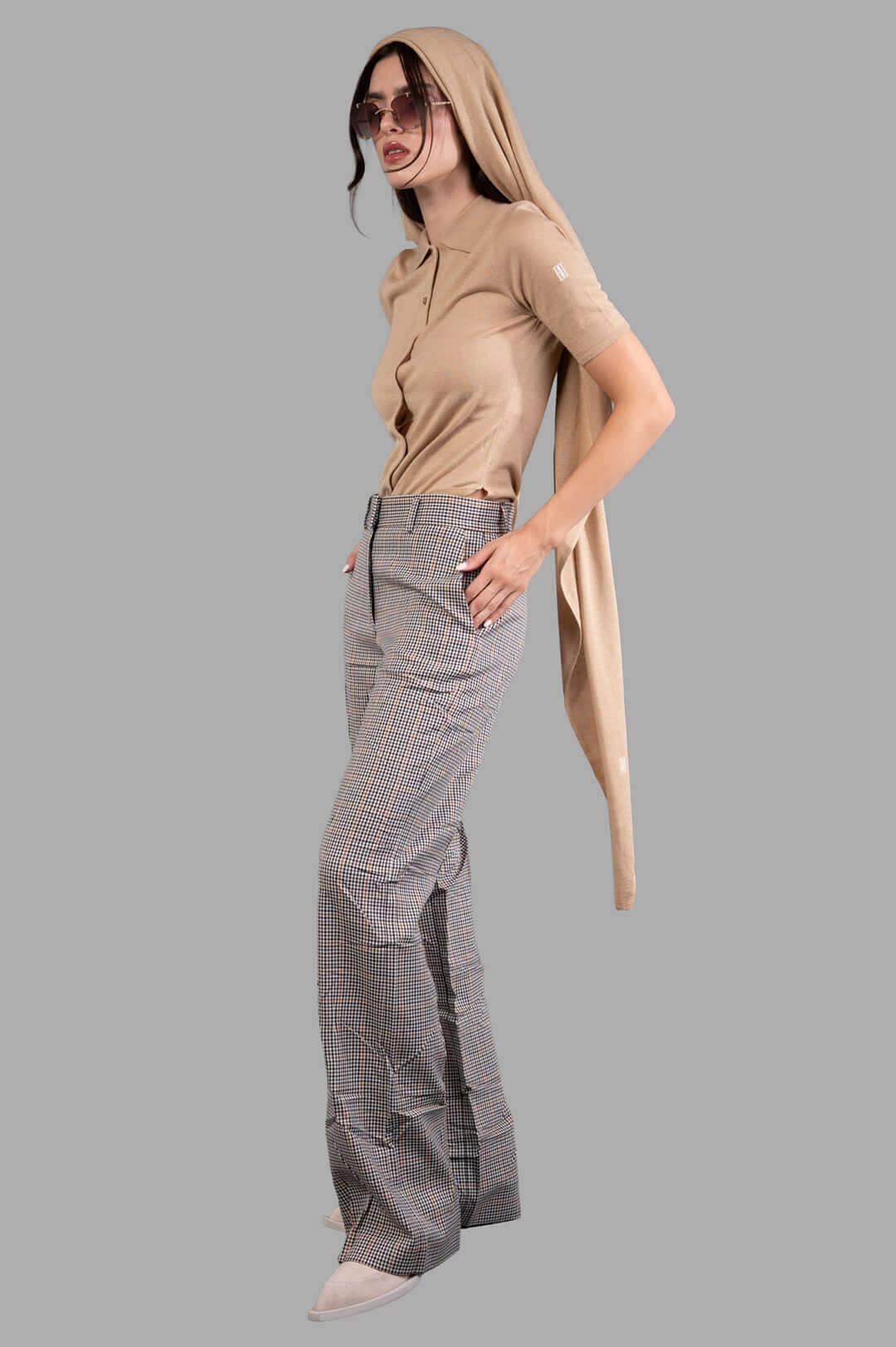 By Malene Birger Dotta Blouse in beige, front view on-model with collar and buttons, paired with checked trousers.