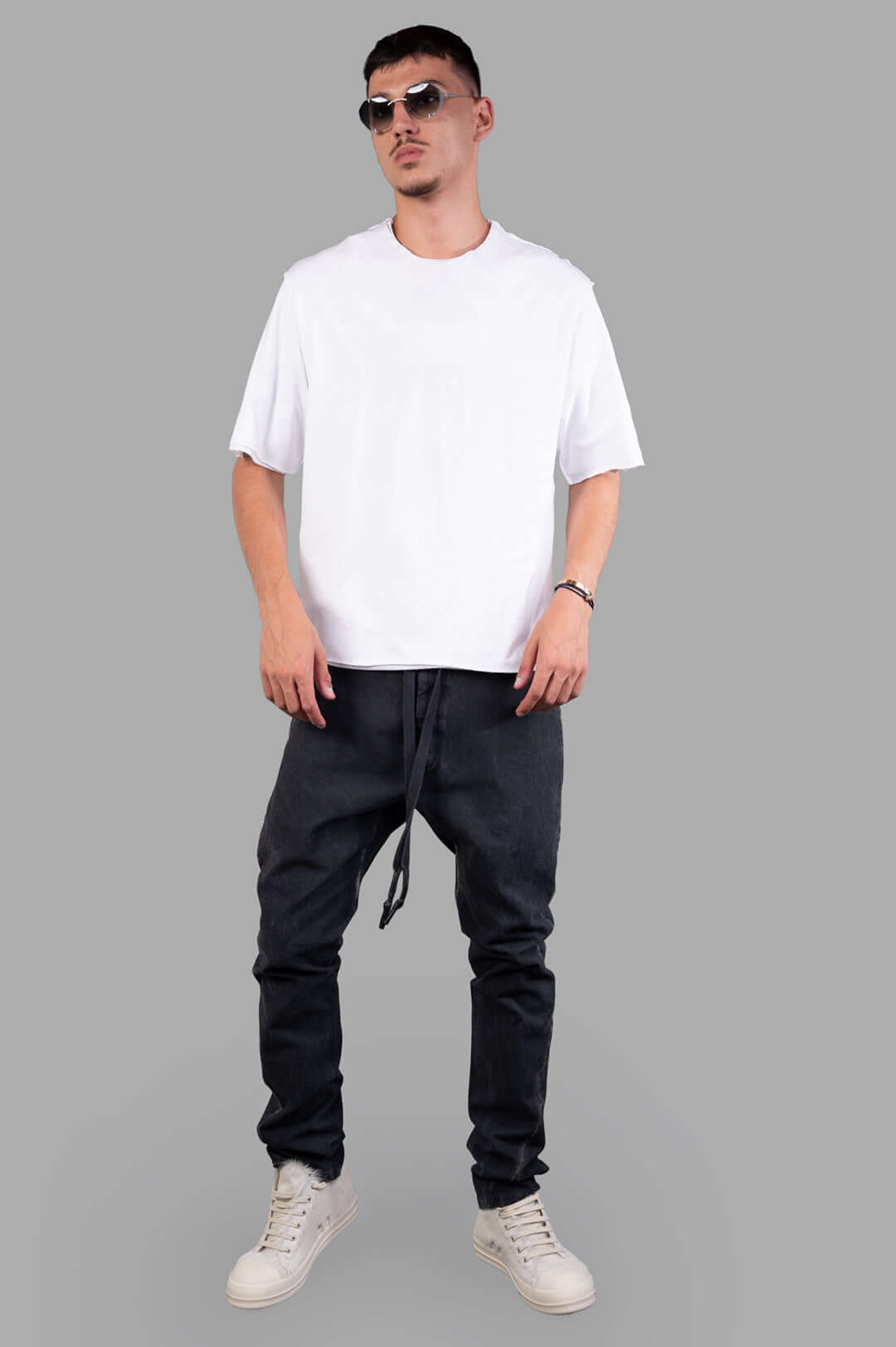 Isaac Sellam Carrot-fit Trousers, front view on-model with white shirt and sneakers, image 1.